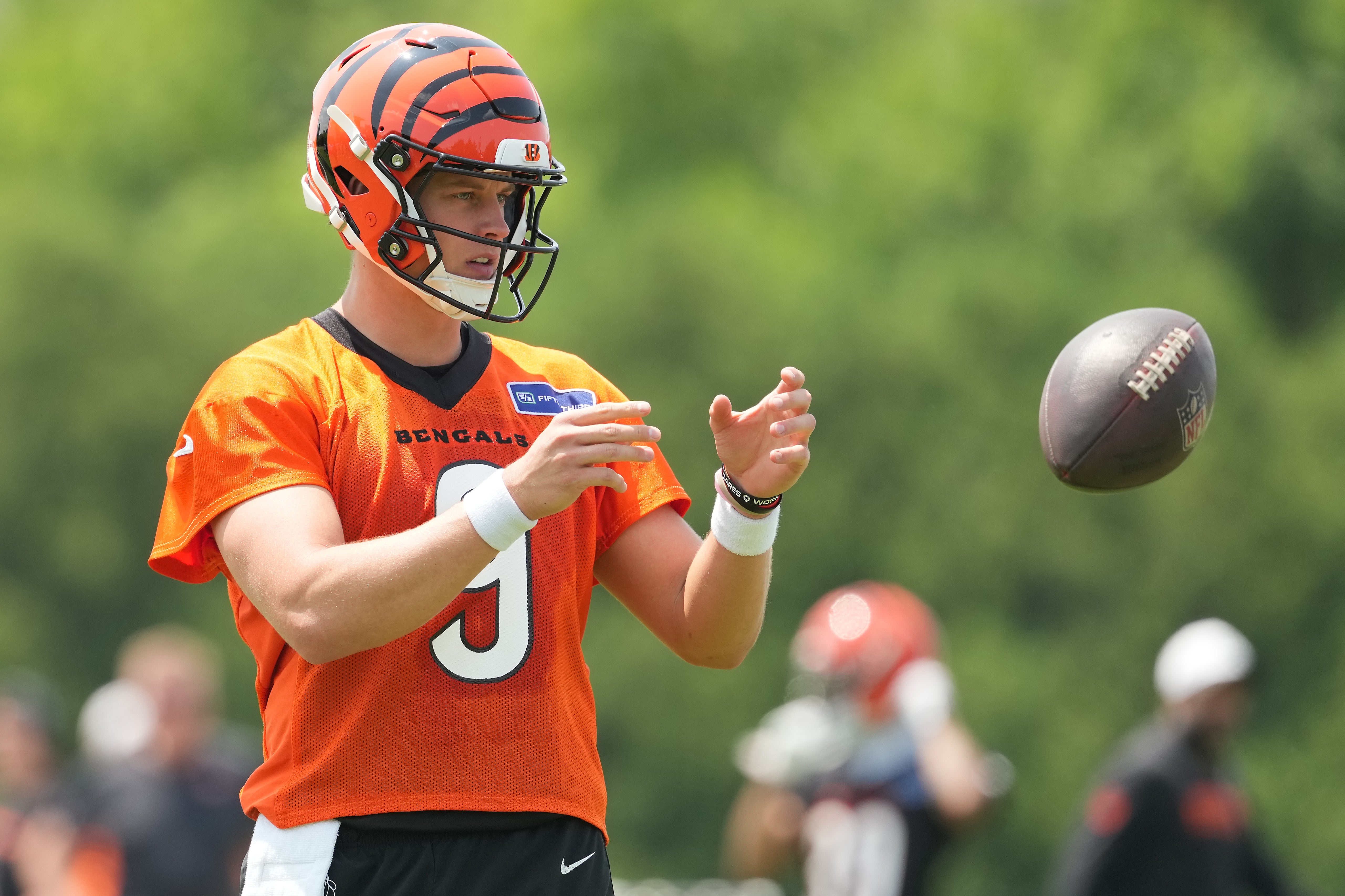 Jun 10, 2025; Cincinnati, OH, USA; Cincinnati Bengals quarterback Joe Burrow (9) catches a ball during practice at Paycor Stadium.