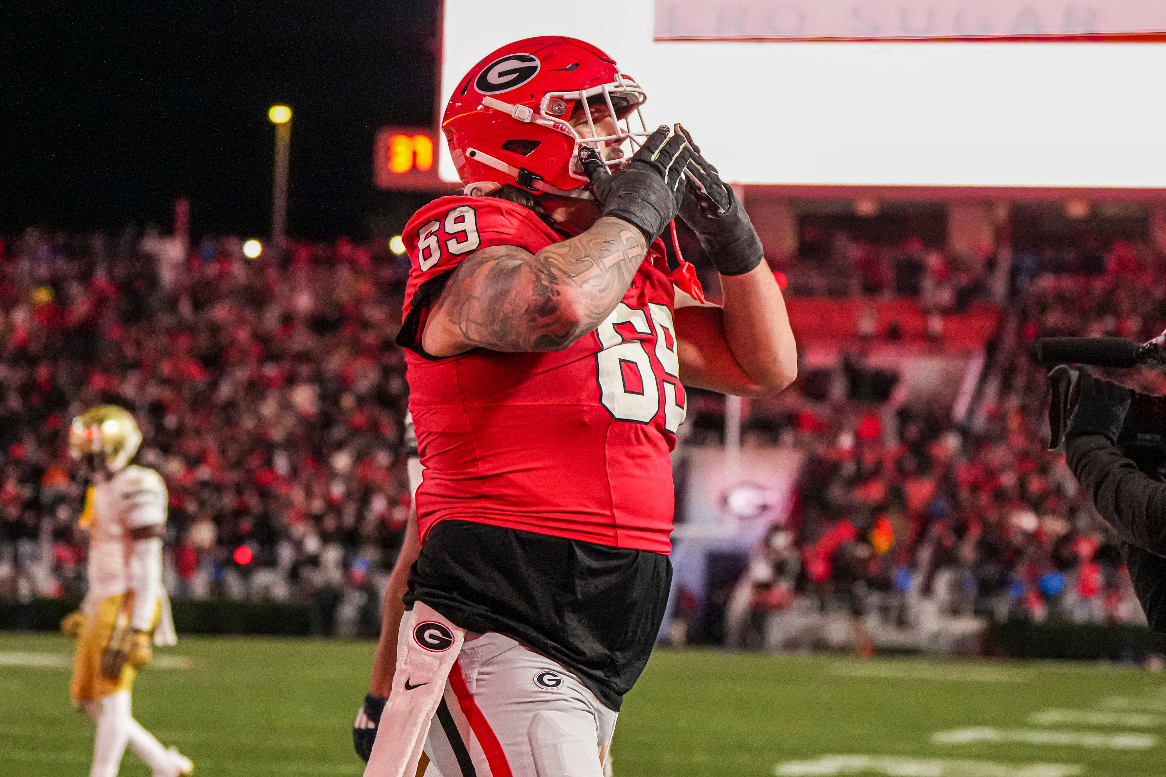 Georgia Bulldogs offensive lineman Tate Ratledge (69) reacts after a touchdown against the Georgia Tech Yellow Jackets during overtime at Sanford Stadium.