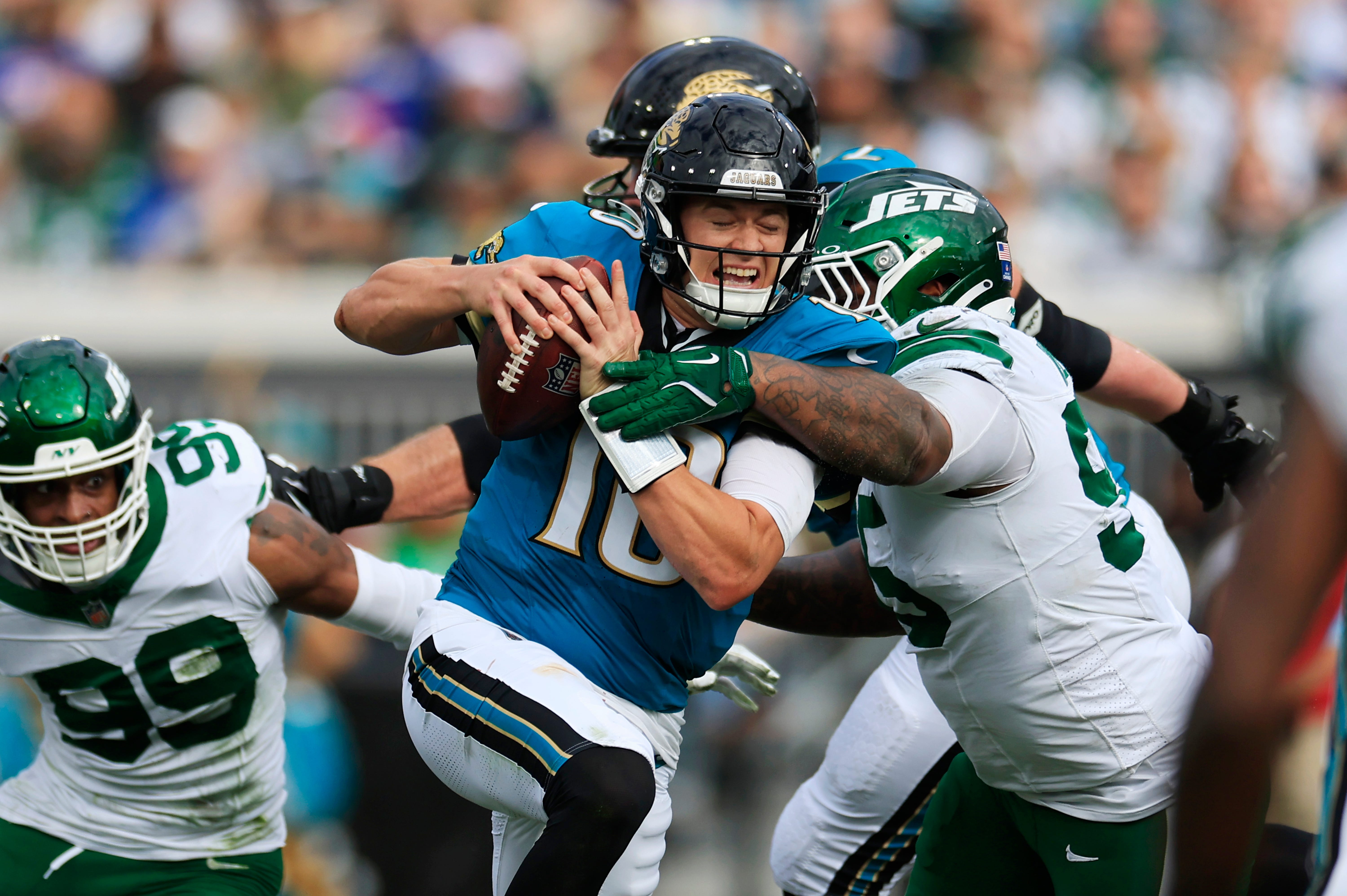 Jacksonville Jaguars quarterback Mac Jones (10) steps up in the pocket to run as pressured by New York Jets defensive tackle Quinnen Williams (95) during the second quarter Sunday, Dec. 15, 2024 at EverBank Stadium in Jacksonville, Fla.