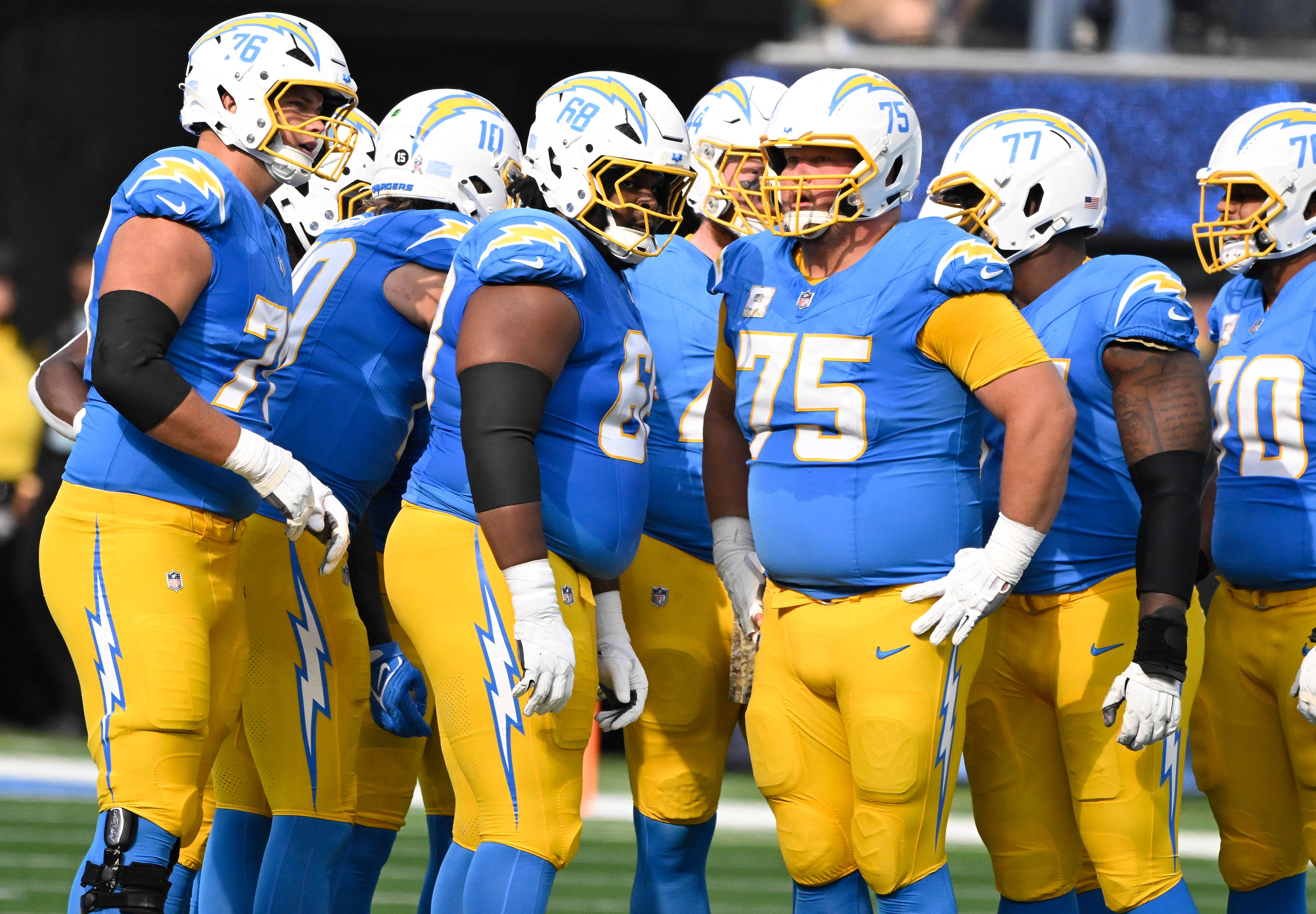 Los Angeles Chargers offensive tackle Joe Alt (76), quarterback Justin Herbert (10), guard Jamaree Salyer (68), fullback Scott Matlock (44), center Bradley Bozeman (75), guard Zion Johnson (77), and offensive tackle Rashawn Slater (70) during and NFL game against the Tennessee Titans at SoFi Stadium.