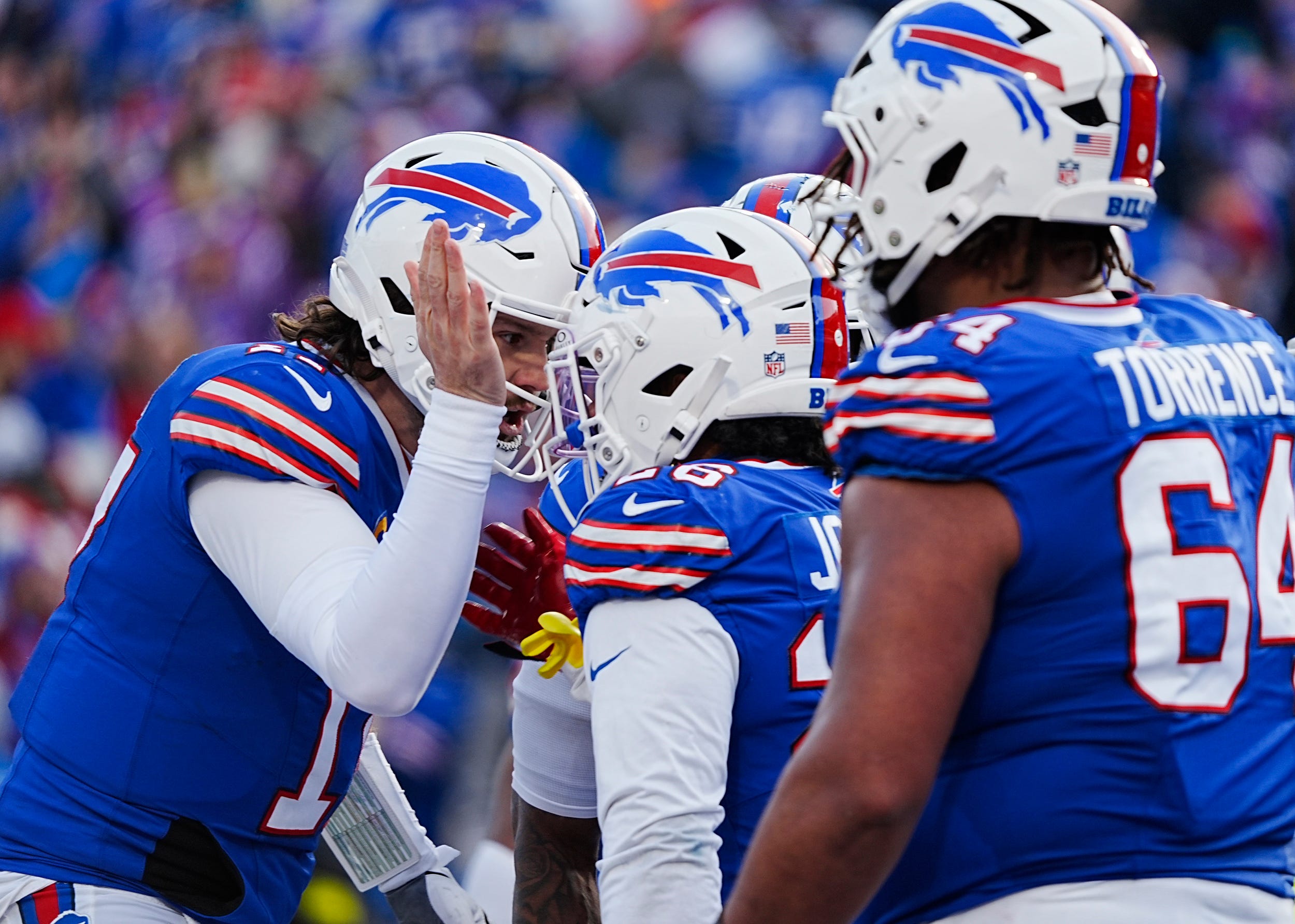 Buffalo Bills quarterback Josh Allen (17) talks in the huddle about the two point conversion play during the second half of the Buffalo Bills wild card game against the Denver Broncos at Highmark Stadium in Orchard Park on Jan. 12, 2025.