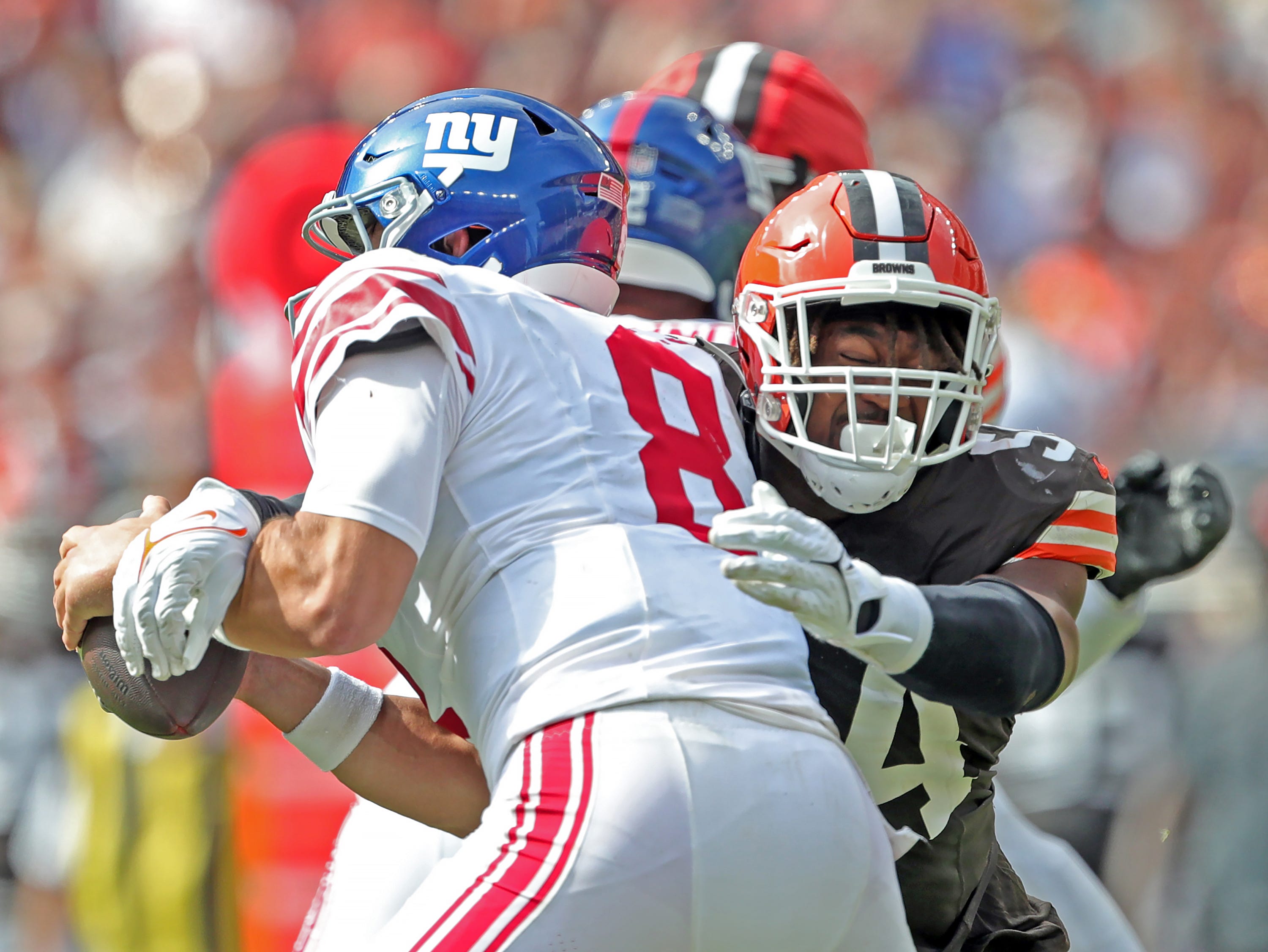 Cleveland Browns defensive end Ogbo Okoronkwo (54) sacks New York Giants quarterback Daniel Jones (8) during the second half of an NFL football game at Huntington Bank Field, Sunday, Sept. 22, 2024, in Cleveland, Ohio.