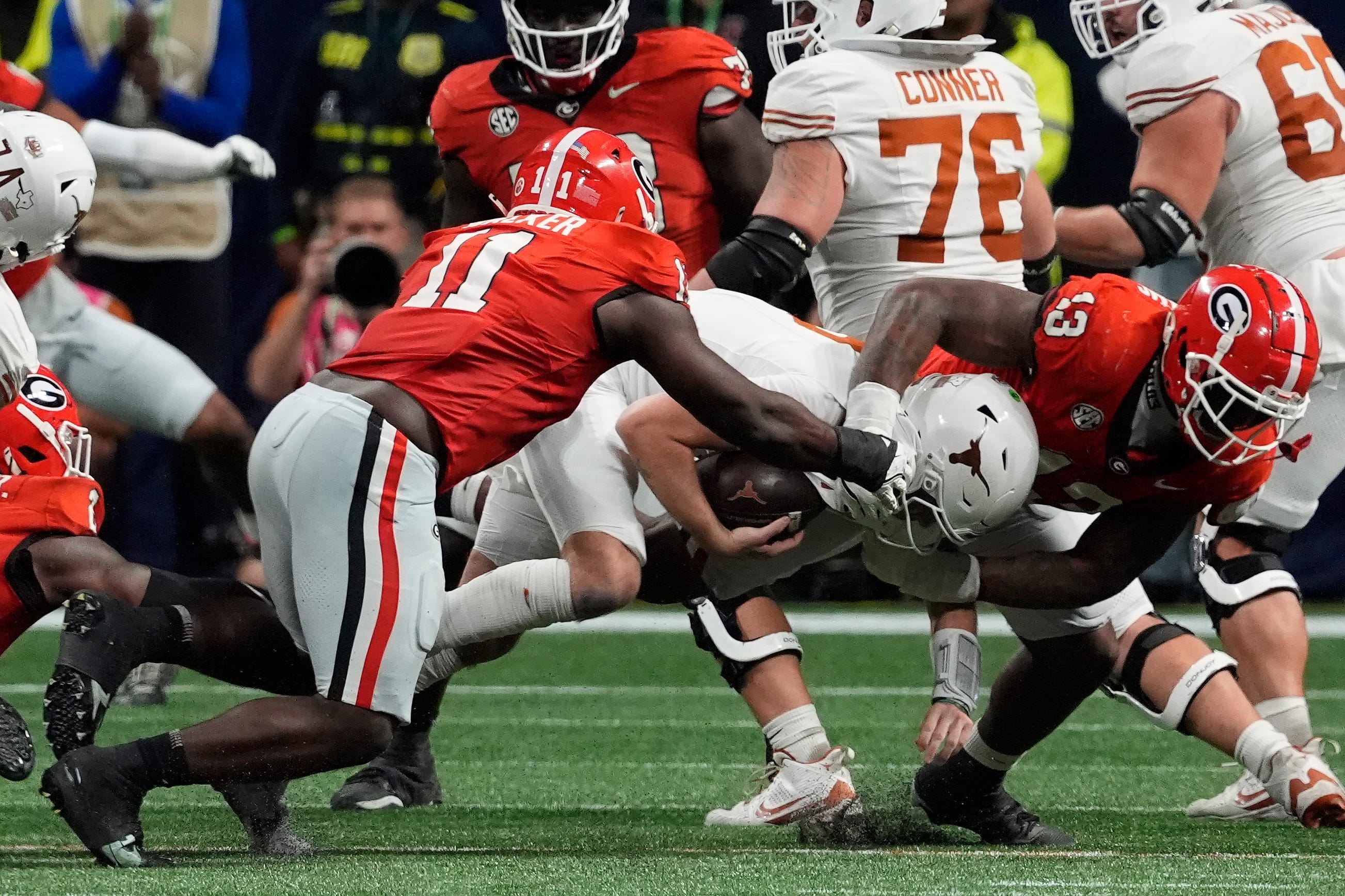 ATLANTA FALCONS: Georgia linebacker Jalon Walker (11) and Georgia defensive lineman Mykel Williams (13) take down Texas quarterback Quinn Ewers (3) during the second half of the SEC championship game.