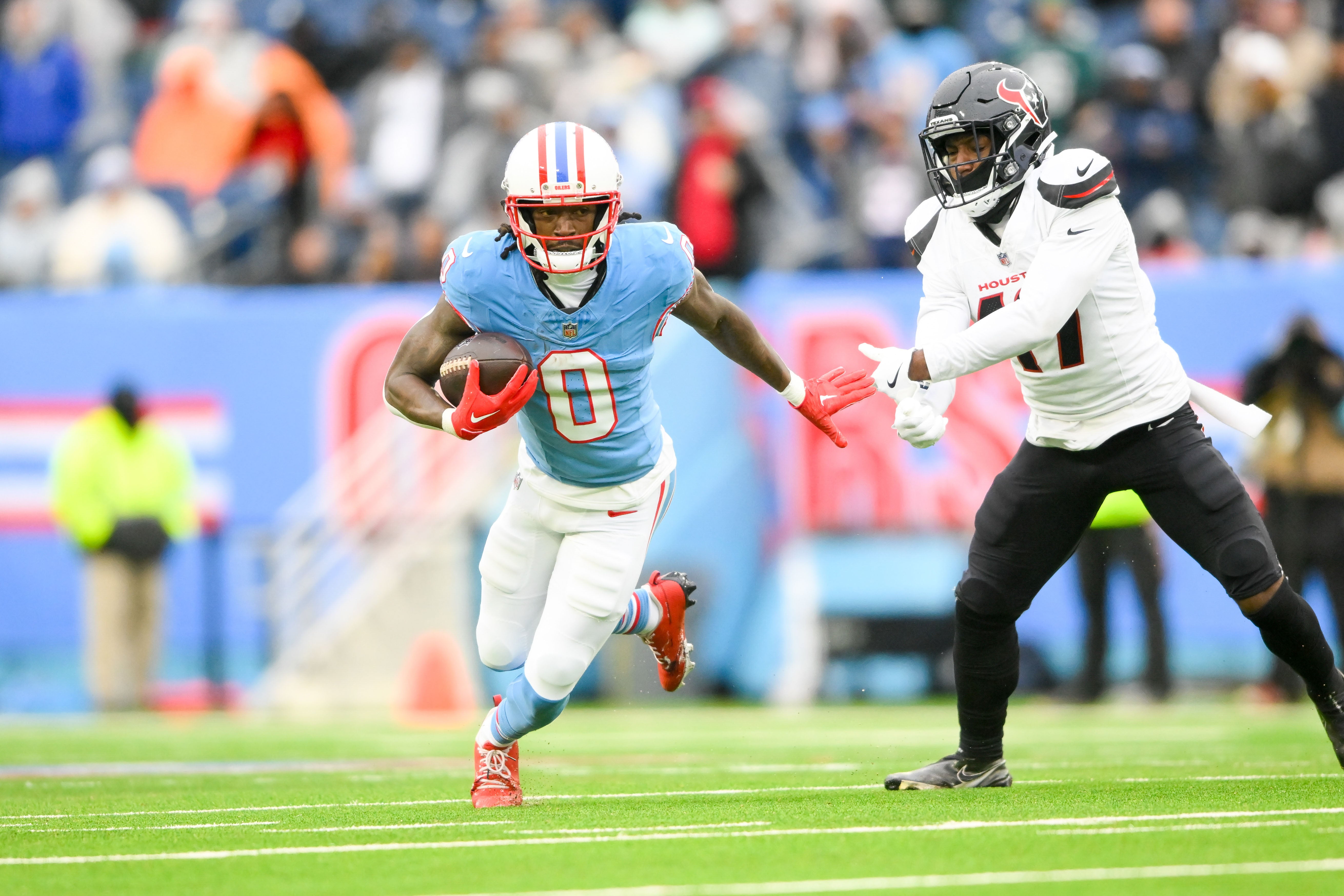 Jan 5, 2025; Nashville, Tennessee, USA; Houston Texans linebacker Azeez Al-Shaair (0) breaks the tackle of Houston Texans cornerback Kris Boyd (17) during the first half at Nissan Stadium.