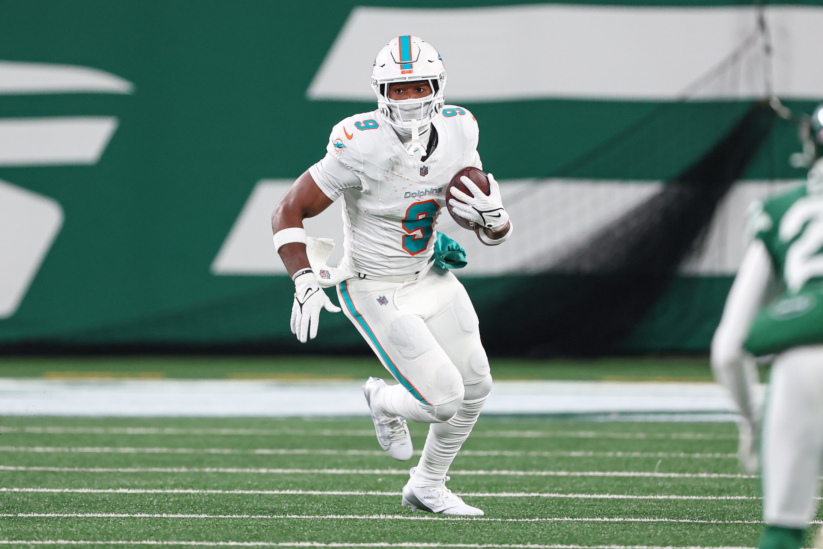 Jan 5, 2025; East Rutherford, New Jersey, USA; Miami Dolphins tight end Jonnu Smith (9) gains yards after catch during the first half against the New York Jets at MetLife Stadium.