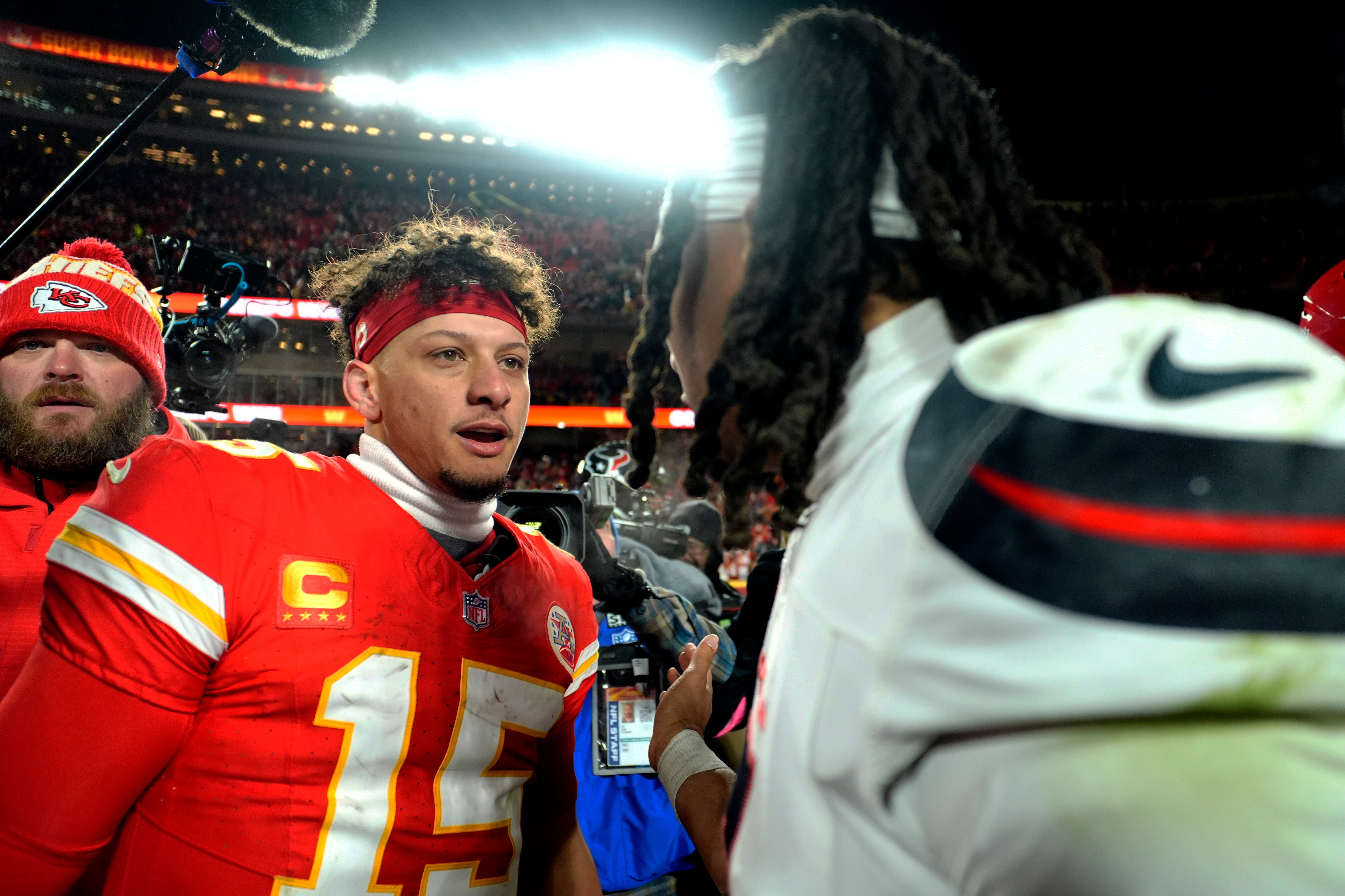 Kansas City Chiefs quarterback Patrick Mahomes (15) meets with Houston Texans quarterback C.J. Stroud (7) after a 2025 AFC divisional round game at GEHA Field at Arrowhead Stadium.