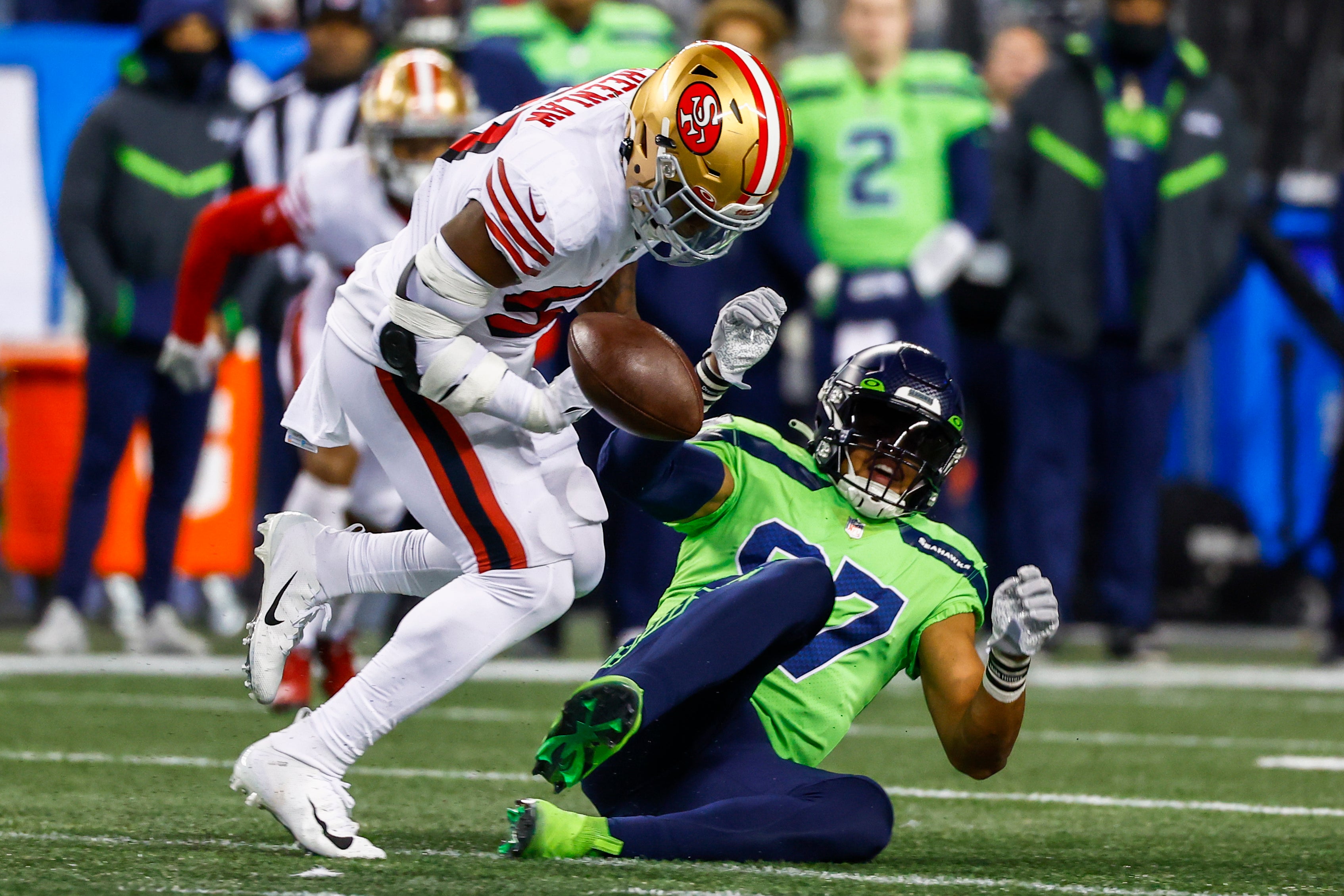 San Francisco 49ers linebacker Dre Greenlaw (57) drops a potential interception against Seattle Seahawks tight end Noah Fant (87) during the first quarter at Lumen Field.