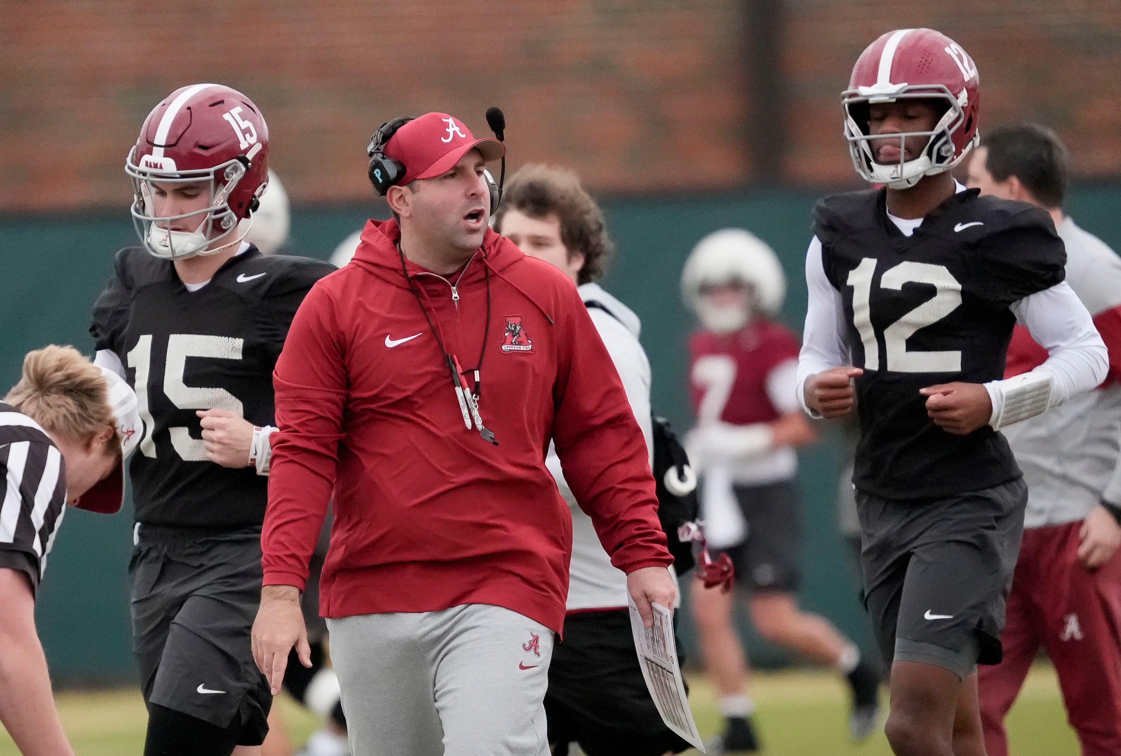 Mar 5, 2025; Tuscaloosa, AL, USA; Quarterbacks coach Nick Seridan walks between quarterbacks Ty Simpson (15) and Keelon Russell (12)during Spring Practice for the Crimson Tide.
