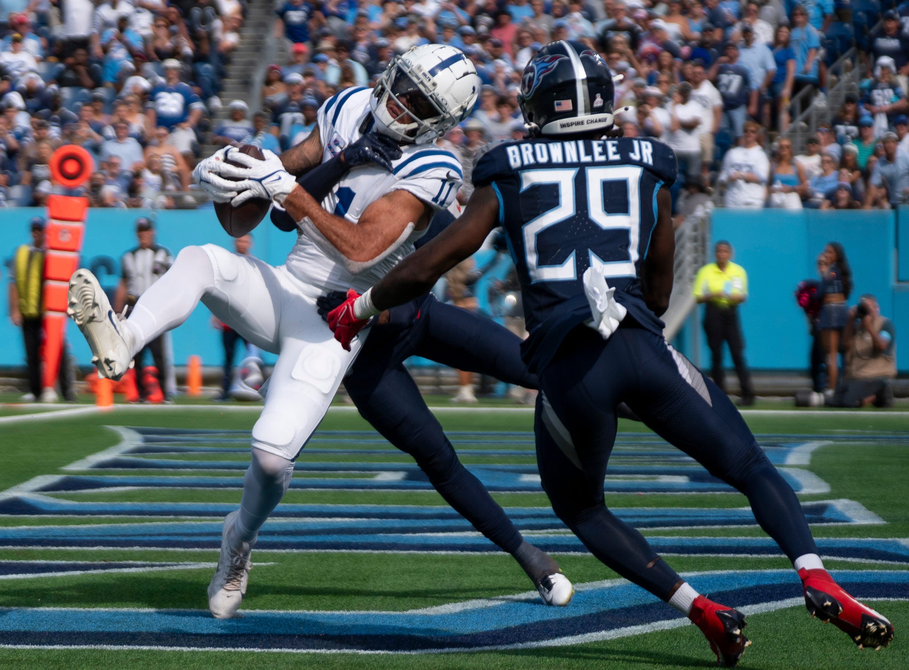 Indianapolis Colts wide receiver Michael Pittman Jr. (11) pulls down a touchdown pass while guarded by Tennessee Titans cornerback L'Jarius Sneed (38) and ornerback Jarvis Brownlee Jr. (29) during the fourth quarter of their game at Nissan Stadium in Nashville, Tenn., Sunday, Oct. 13, 2024. The score proved the be the winning touchdown with a final of Indianapolis 20 and Tennessee 17.