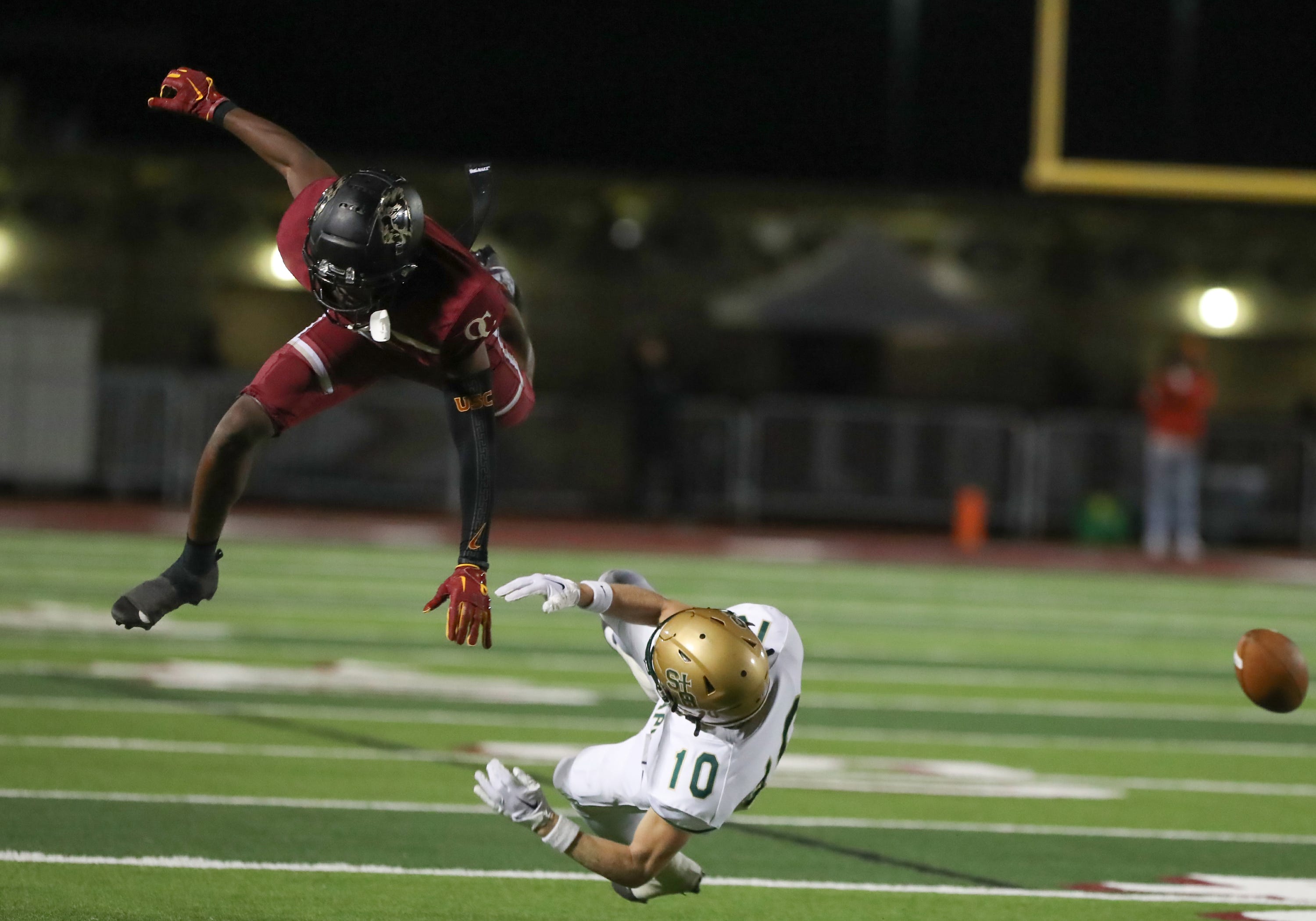 Oaks Christian's Davon Benjamin and St. Bonaventure's Jack Cunningham (10) collide during the fourth quarter of the Marmonte League title game on Friday, Oct. 27, 2023, at Oak Christian's Thorson Stadium. Oaks Christian won 13-10.