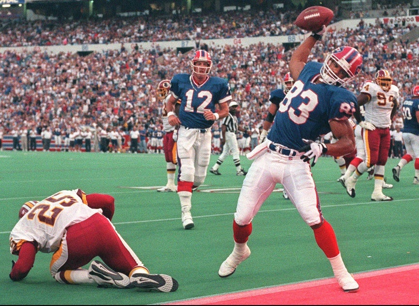 Andre Reed (83) and Jim Kelly have had their differences last season but they say its all behind them now. Reed celebrates this TD catch from Kelly against the Redskins in preseason. Redskins cornerback, Tom Carter beat on the play.