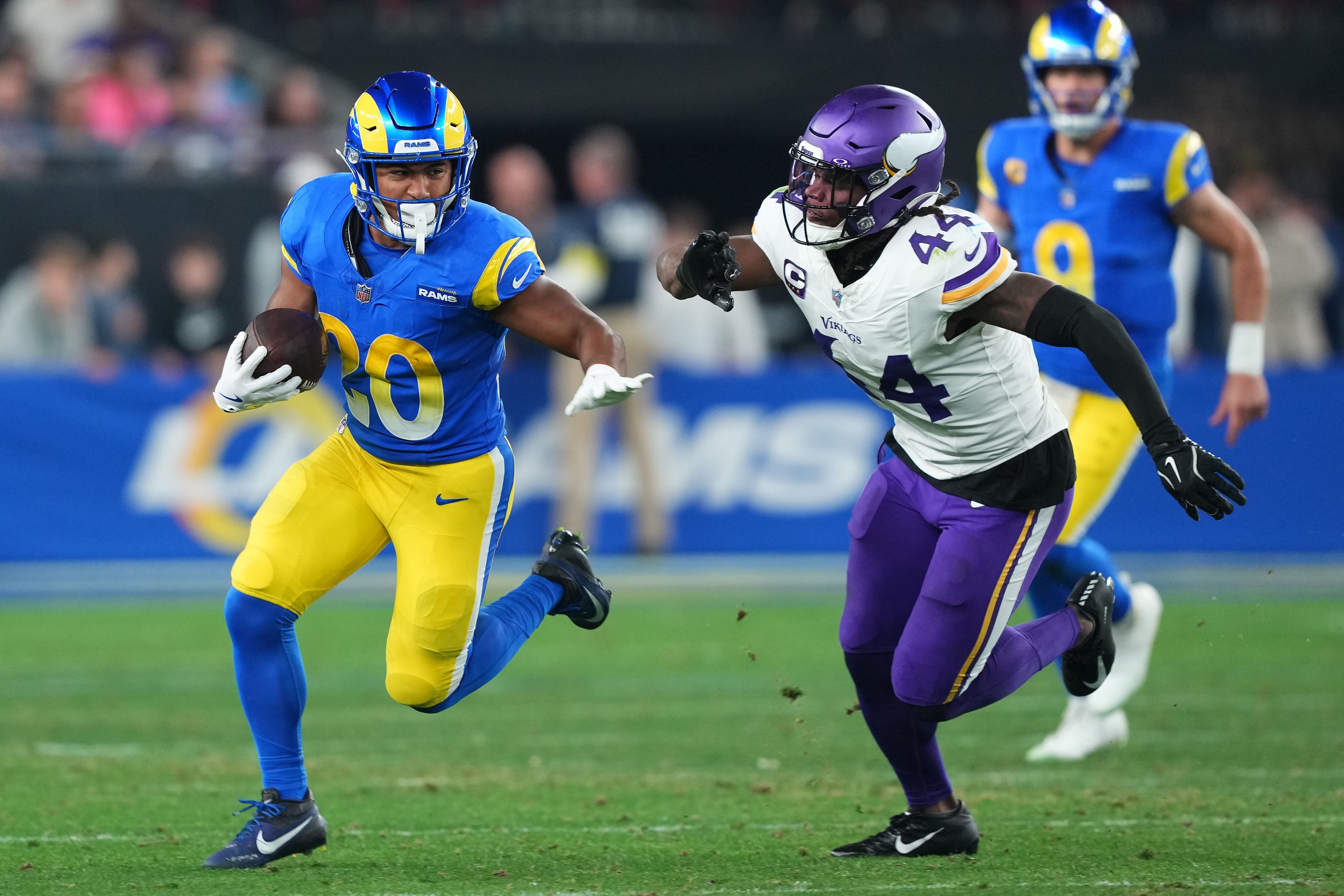 Jan 13, 2025; Glendale, AZ, USA; Los Angeles Rams running back Ronnie Rivers (20) rushes the ball against Minnesota Vikings safety Josh Metellus (44) during the second half in an NFC wild card game at State Farm Stadium.