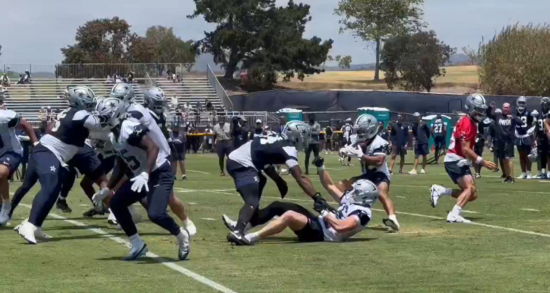 Sam Williams plants TE Tyler Neville during first practice of Dallas Cowboys training camp.