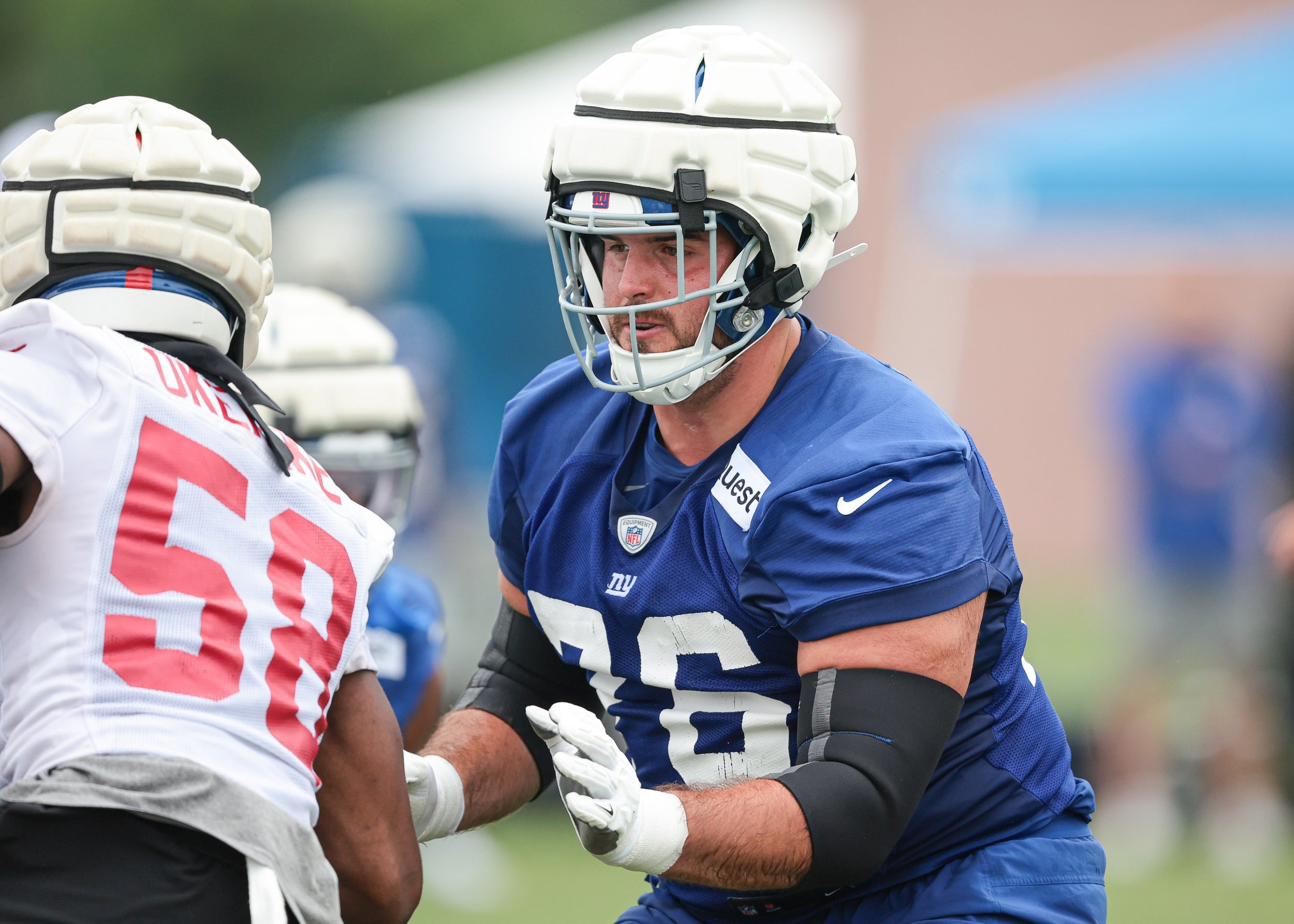 New York Giants guard Jon Runyan (76) blocks linebacker Bobby Okereke (58) during training camp at Quest Diagnostics Training Facility.