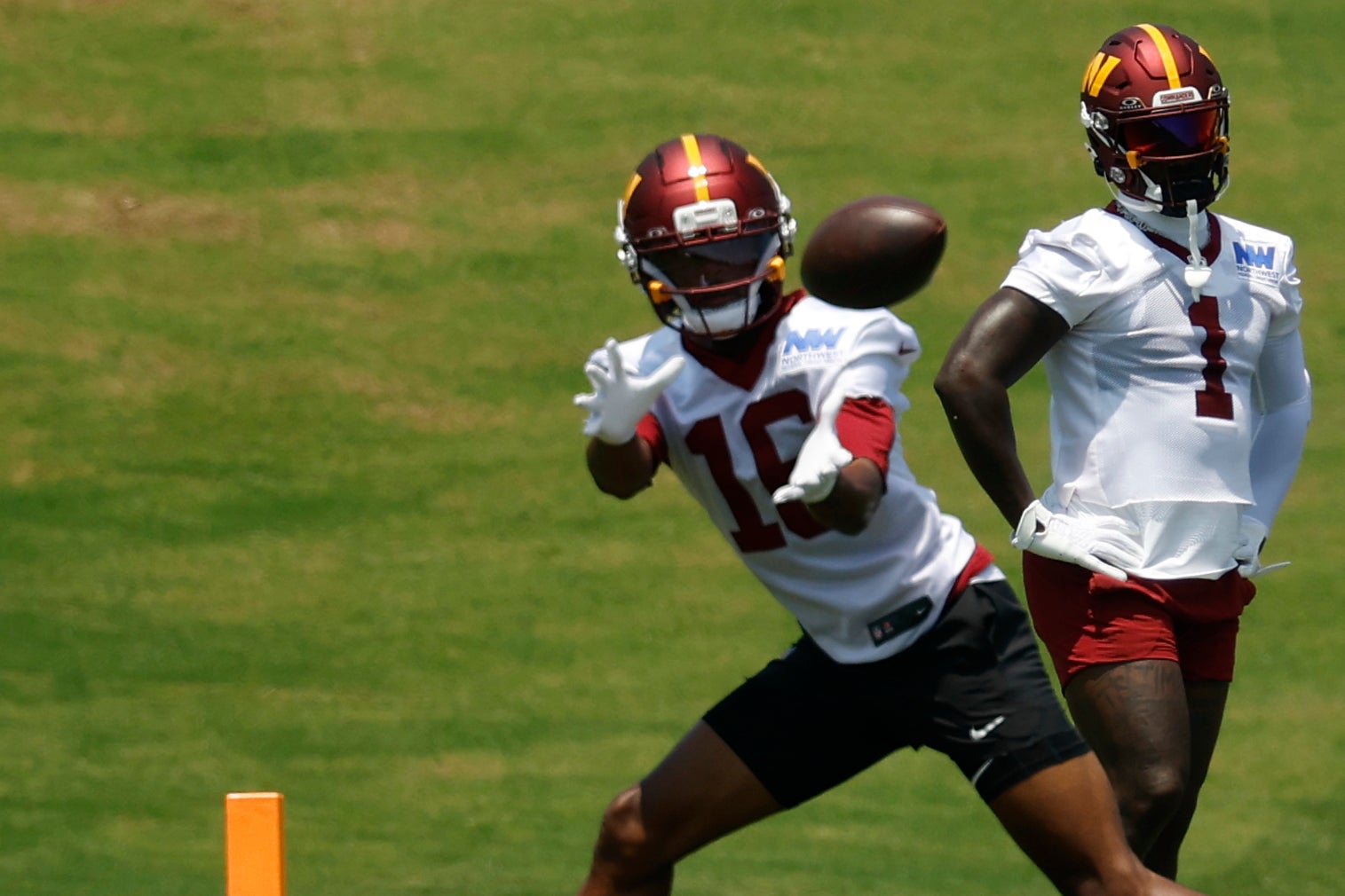 Jun 10, 2025; Ashburn, VA, USA; Washington Commanders wide receiver Deebo Samuel Sr. (1) looks on as Commanders wide receiver Ja'Corey Brooks (16) attempts to catch a pass during drills on day one of minicamp at Commanders Park.