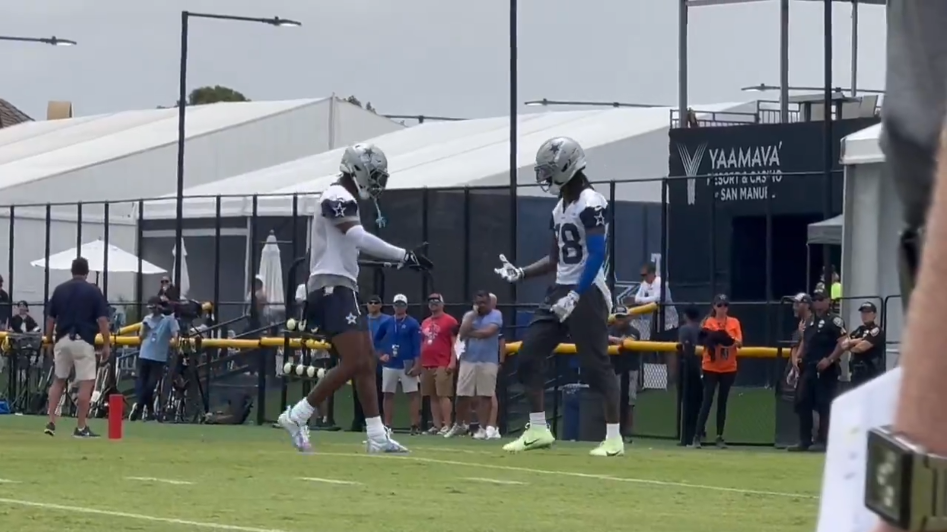 Dallas Cowboys WR CeeDee Lamb and George Pickens celebrate in the end zone after scoring a touchdown in training camp.