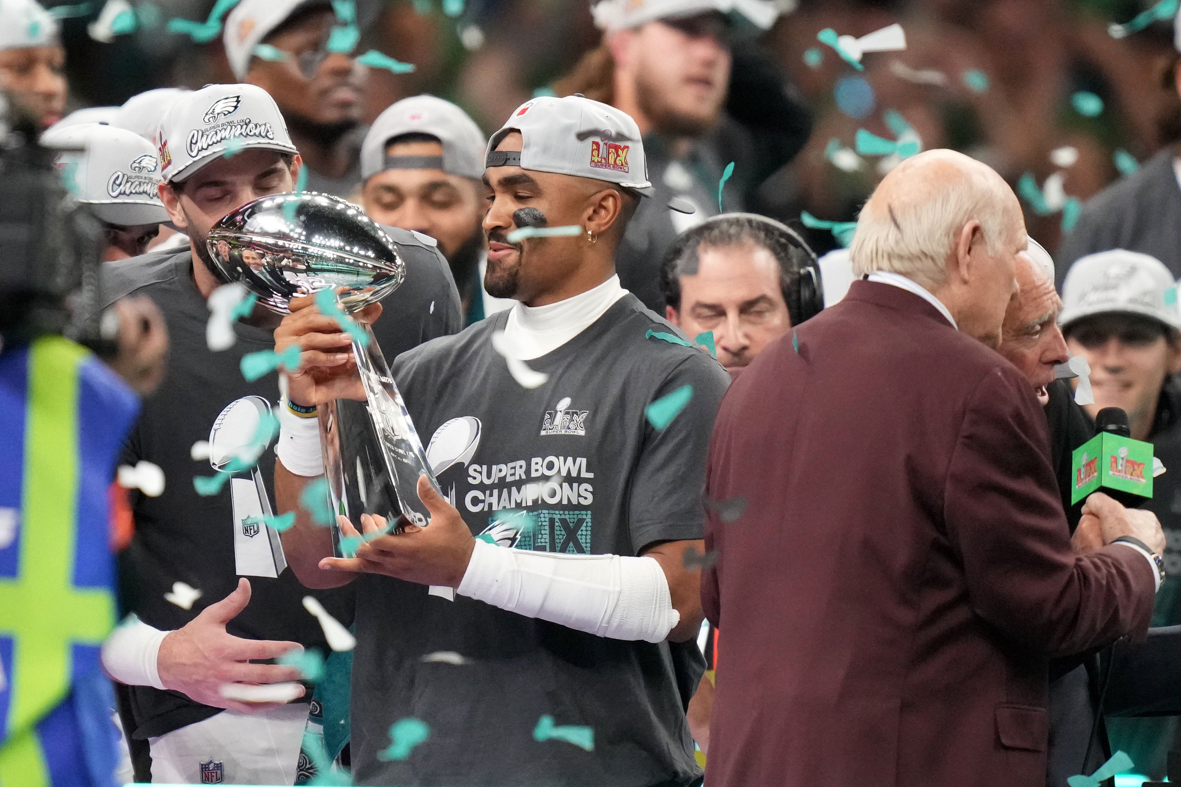 Feb 9, 2025; New Orleans, LA, USA; Philadelphia Eagles quarterback Jalen Hurts (1) hoists the Vince Lombardi Trophy after defeating the Kansas City Chiefs in Super Bowl LIX at Ceasars Superdome.