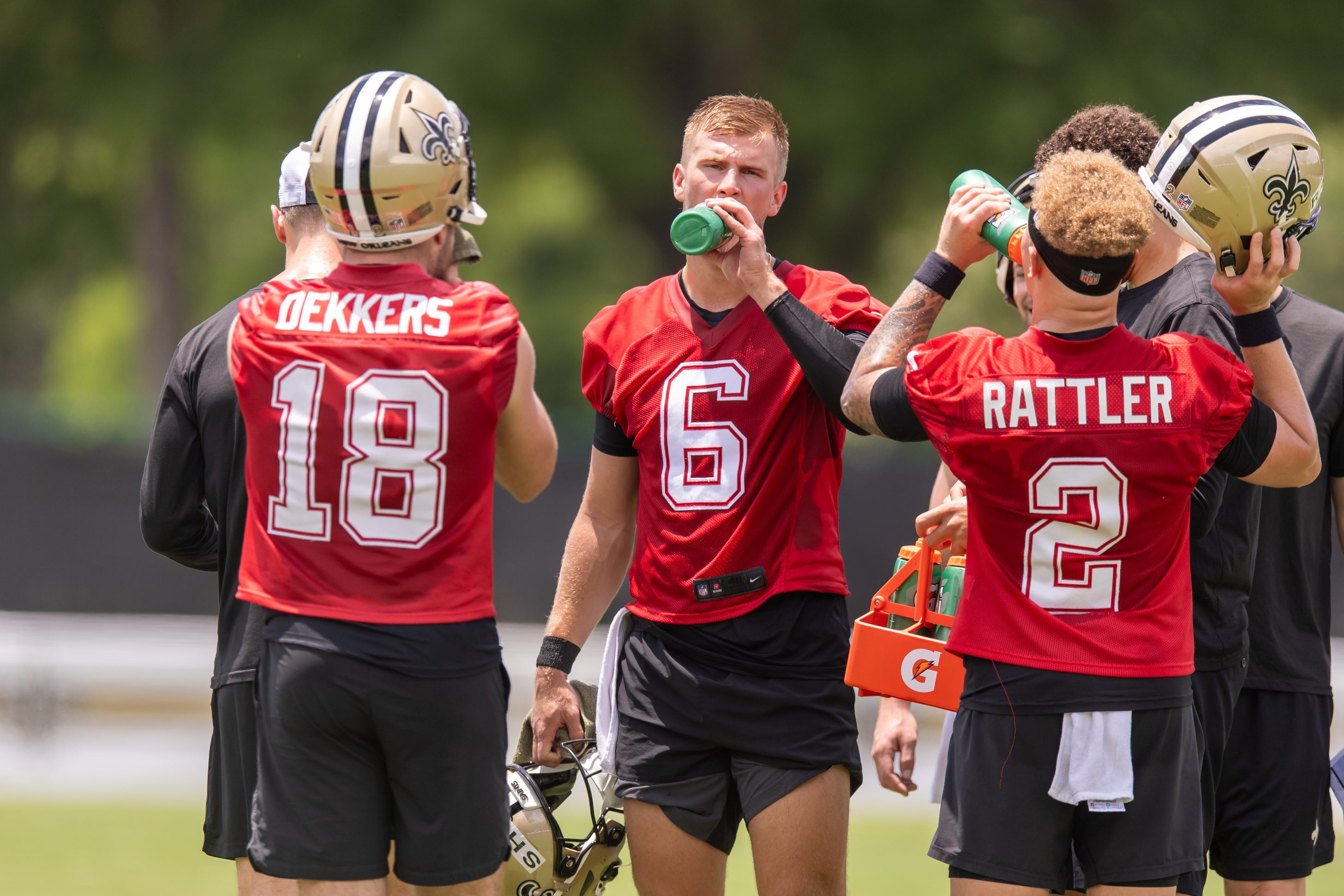 New Orleans Saints quarterback Tyler Shough (6) and quarterback Spencer Rattler (2) and quarterback Hunter Dekkers (18) take a water break during minicamp at Ochsner Sports Performance Center.