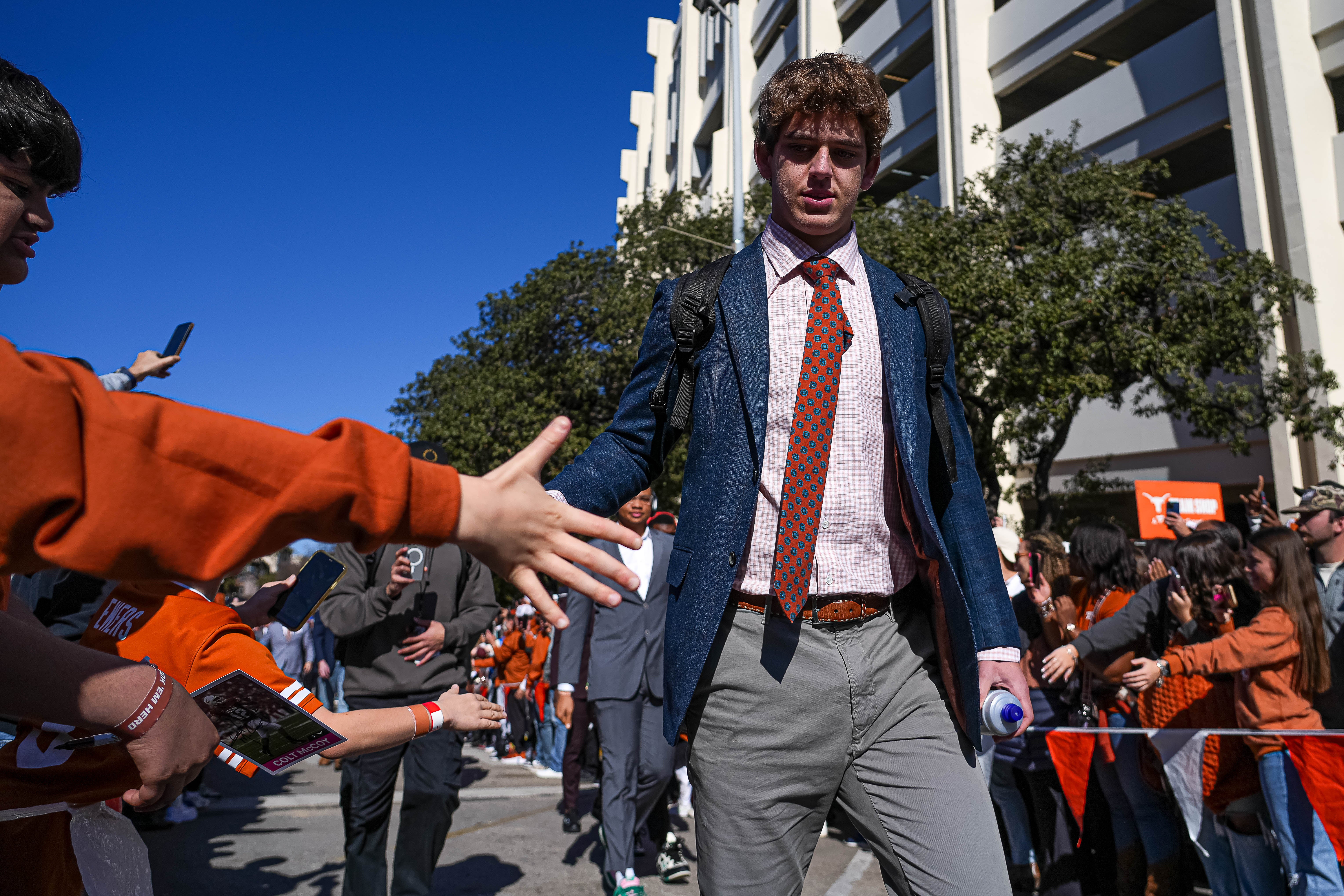 Texas Longhorns quarterback Arch Manning (16) is greeted by fans before a game against the Clemson Tigers in the first round of the College Football Playoffs at Darrell K Royal-Texas Memorial Stadium.