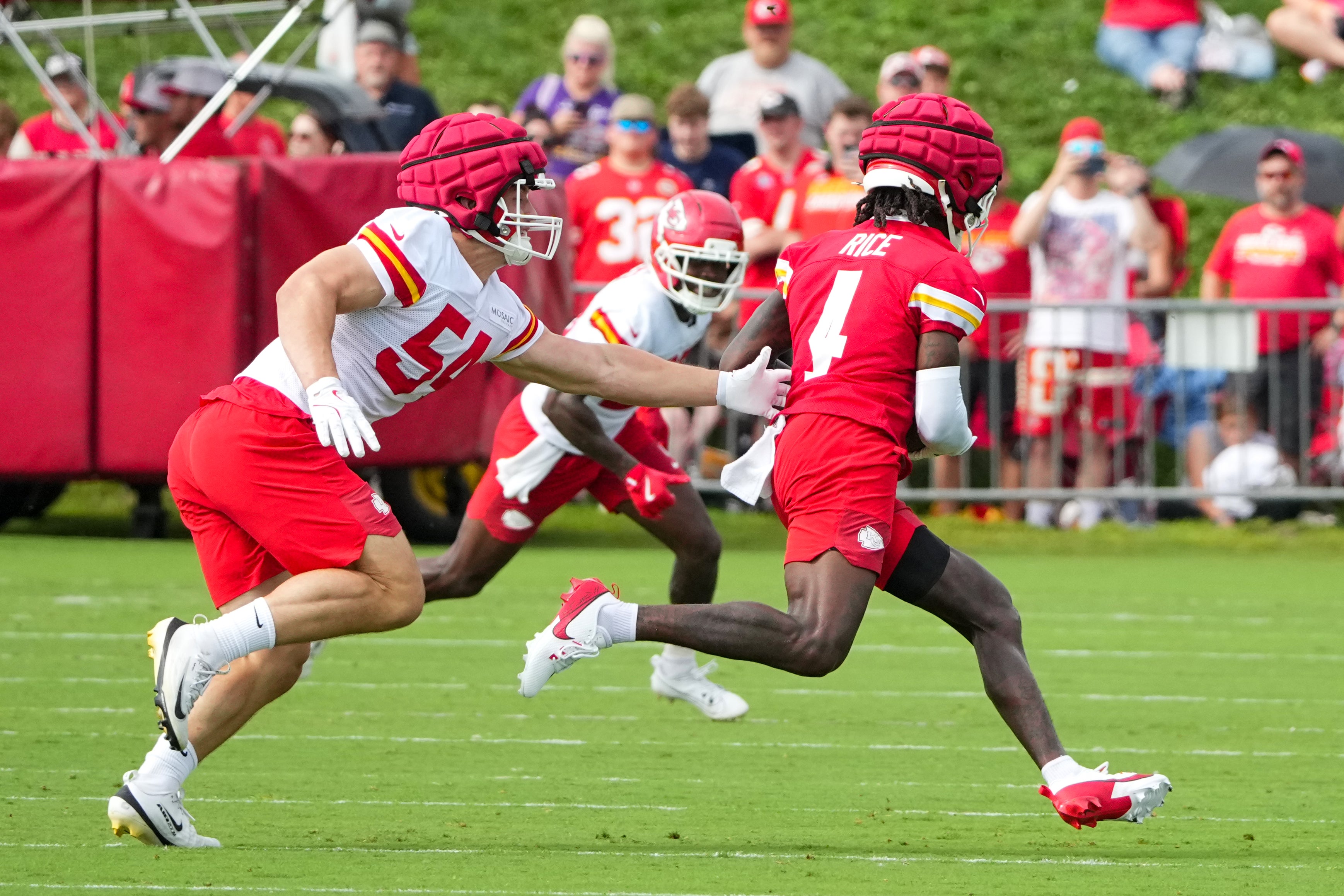 Jul 22, 2025; St. Joseph, MO, USA; Kansas City Chiefs wide receiver Rashee Rice (4) catches a pass as linebacker Leo Chenal (54) defends during training camp at Missouri Western State University.