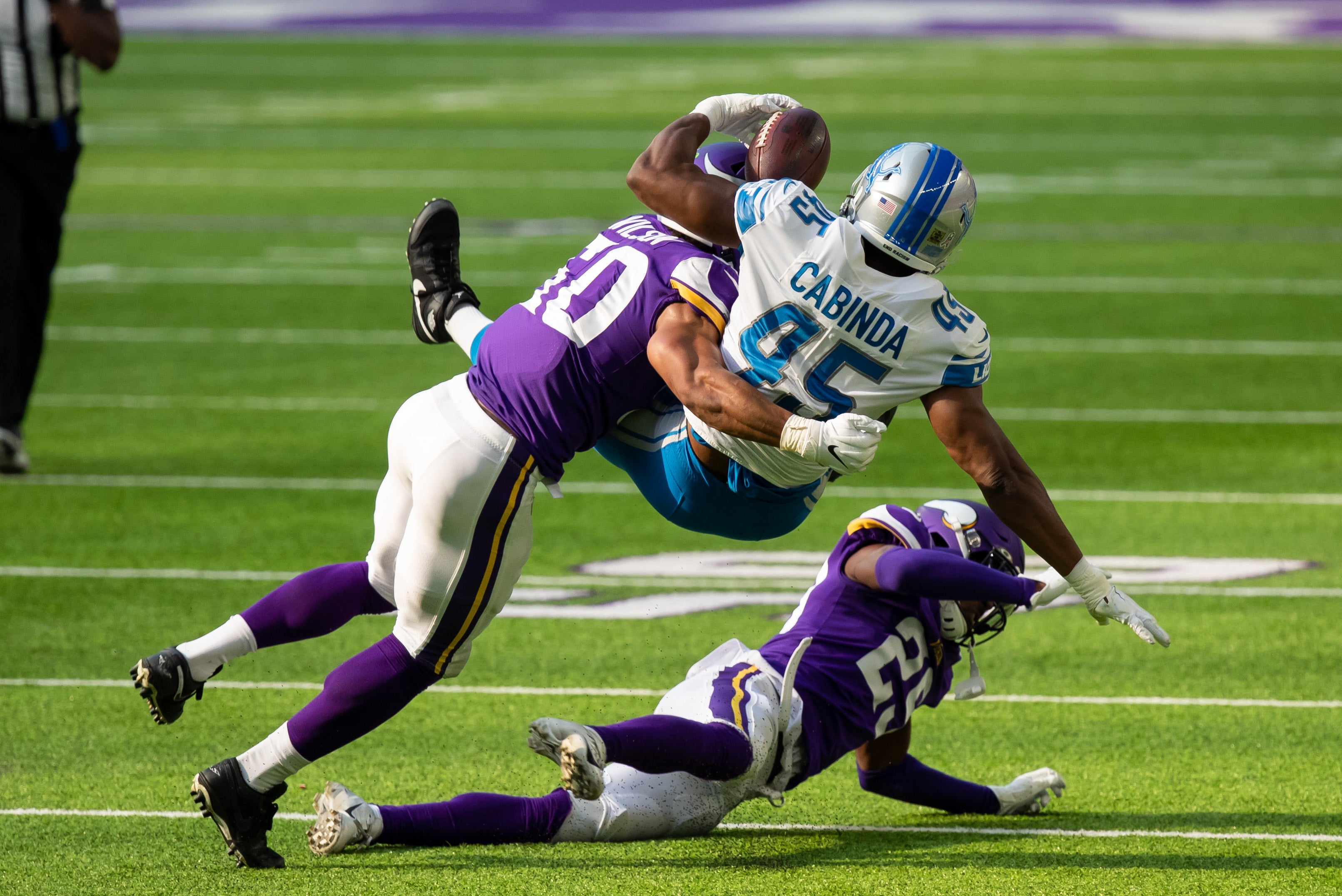 Nov 8, 2020; Minneapolis, Minnesota, USA; Detroit Lions fullback Jason Cabinda (45) is tackled by Minnesota Vikings defensive back Kris Boyd (29) and linebacker Eric Wilson (50) in the second quarter at U.S. Bank Stadium.