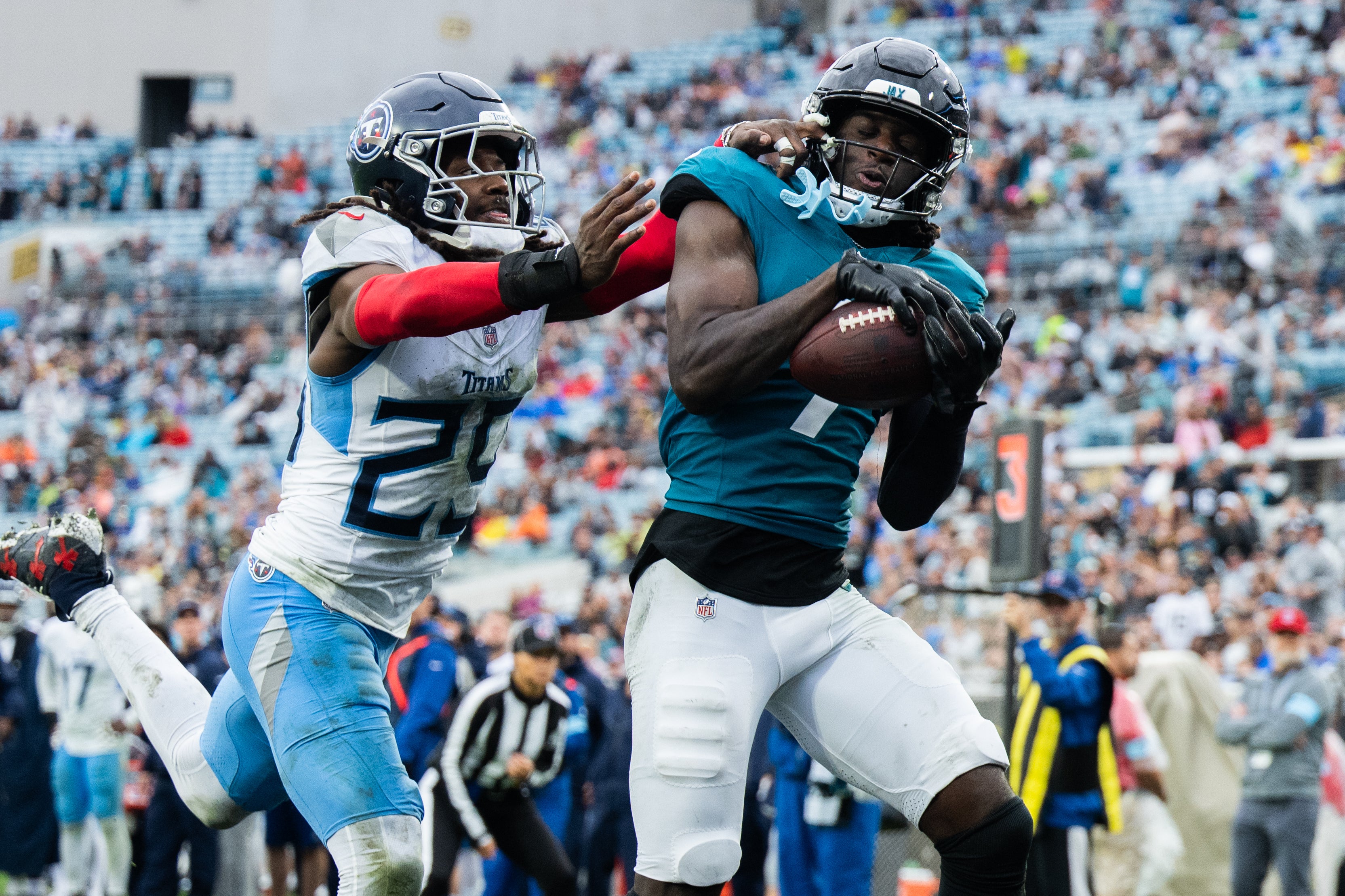 Jacksonville Jaguars wide receiver Brian Thomas Jr (7) catches the ball for a touchdown against Tennessee Titans cornerback Jarvis Brownlee Jr. (29) in the fourth quarter at EverBank Stadium.
