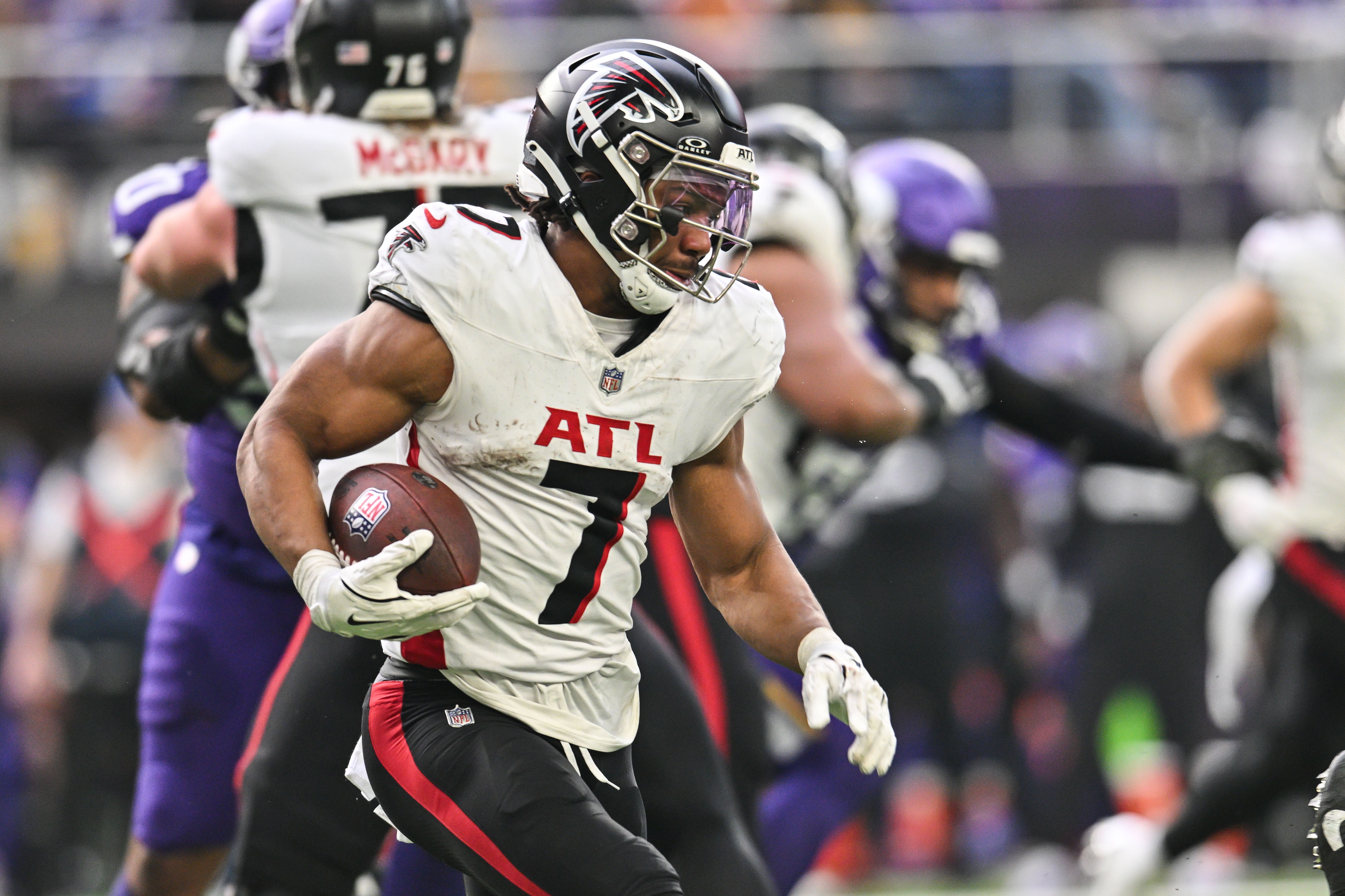 Dec 8, 2024; Minneapolis, Minnesota, USA; Atlanta Falcons running back Bijan Robinson (7) runs the ball against the Minnesota Vikings during the second quarter at U.S. Bank Stadium.