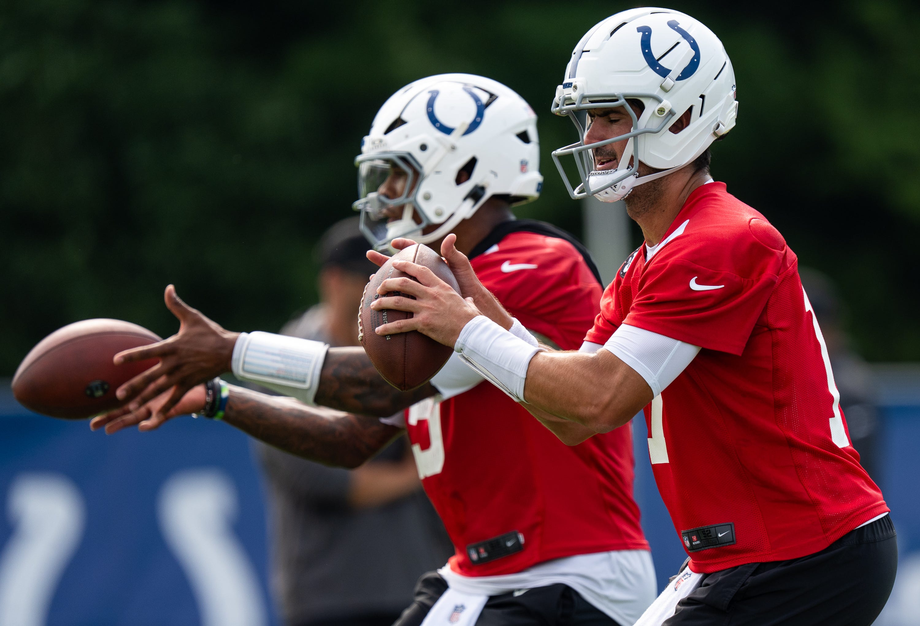 Indianapolis Colts quarterbacks Anthony Richardson Sr. (5) and Daniel Jones (17) pass Friday, July 25, 2025, during training camp held at Grand Park in Westfield.