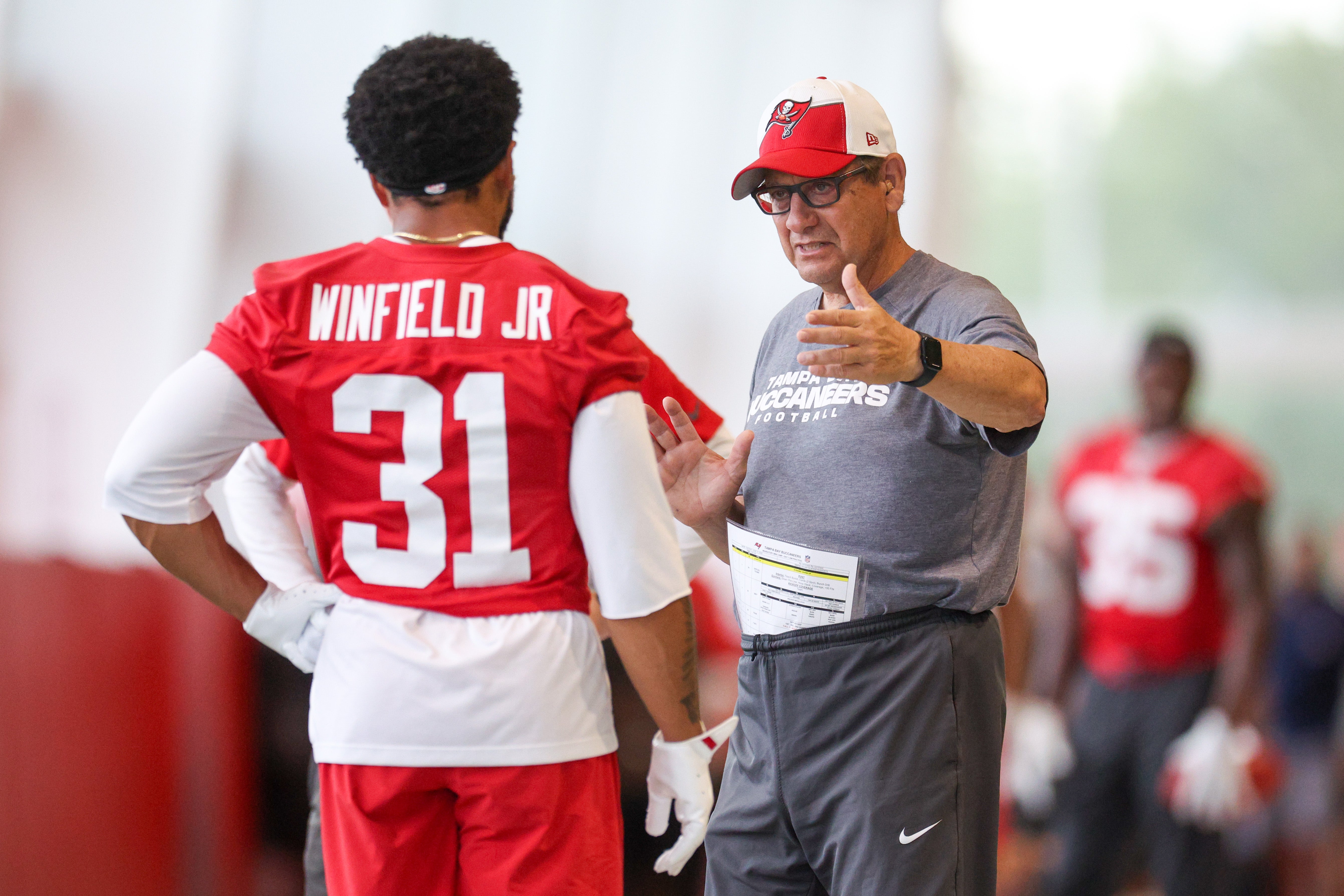 Jun 10, 2025; Tampa Bay, FL, USA; Tampa Bay Buccaneers safeties coach Nick Rapone talks to safety Antoine Winfield Jr. (31) during mini camp at AdventHealth Training Center.