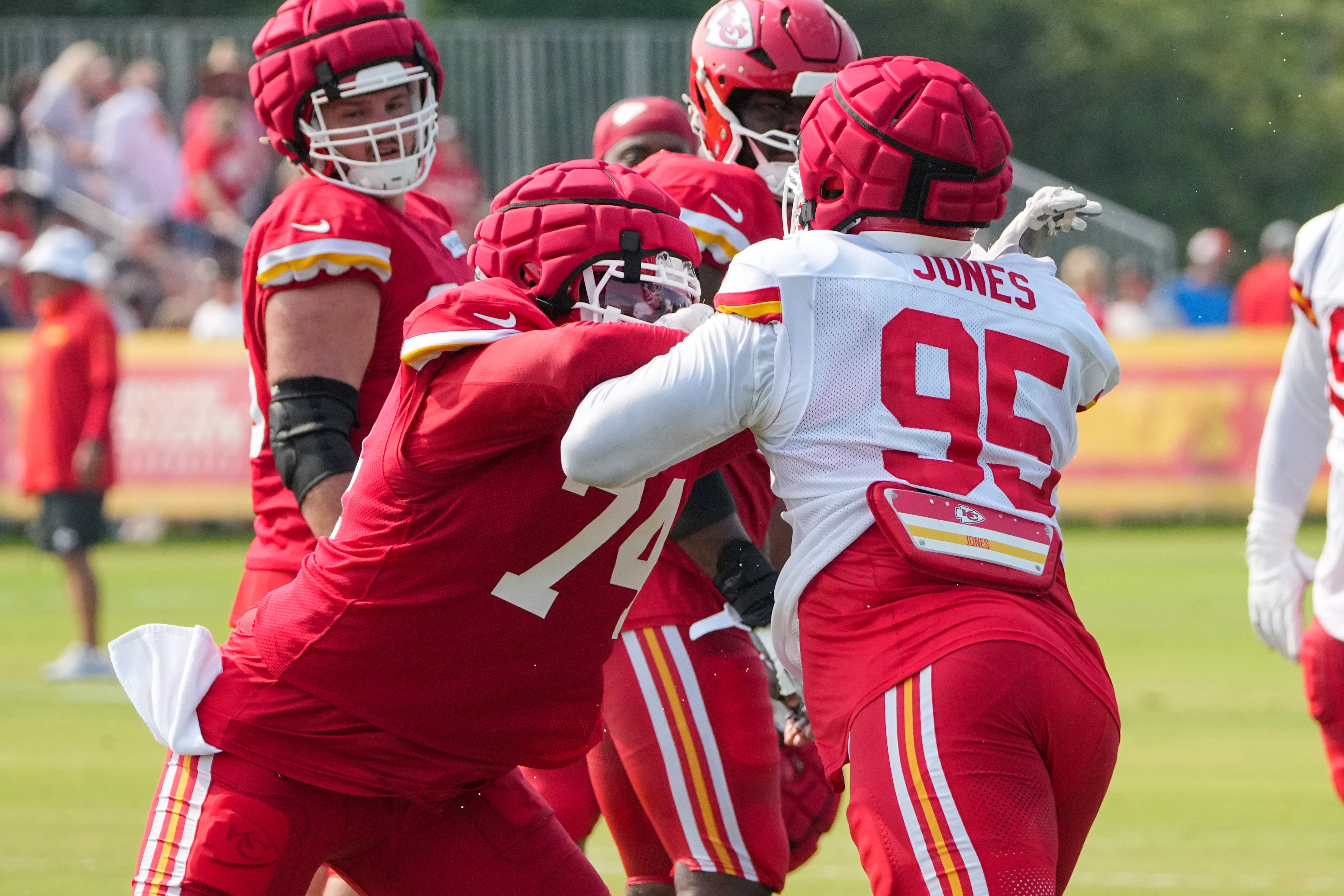 Jul 26, 2024; Kansas City, MO, USA; Kansas City Chiefs offensive tackle Jawaan Taylor (74) and defensive tackle Chris Jones (95) run drills during training camp at Missouri Western State University.