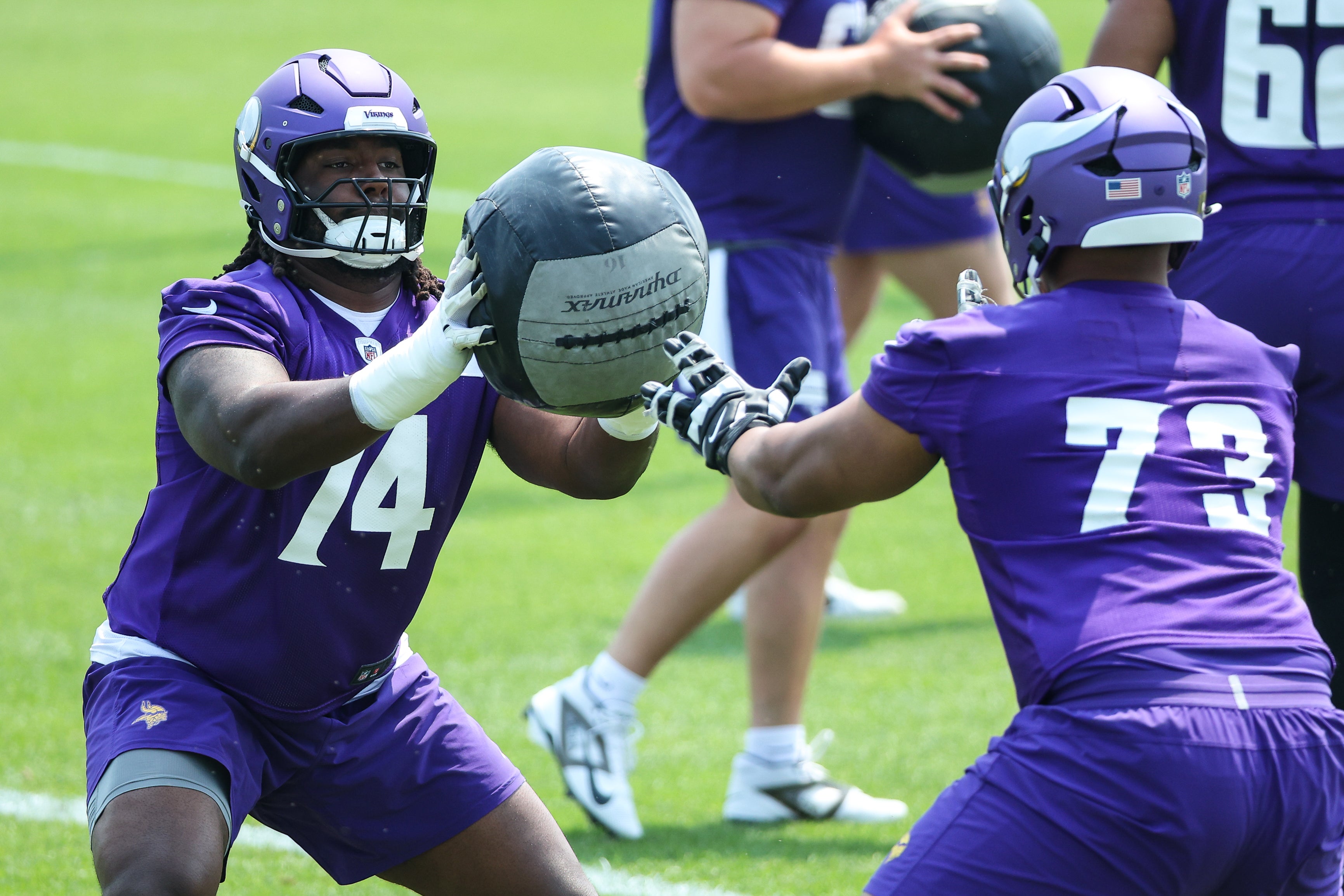 Jun 10, 2025; Minneapolis, MN, USA; Minnesota Vikings guard Donovan Jackson (74) and offensive tackle Walter Rouse (73) practice during minicamp at the Minnesota Vikings Training Facility.