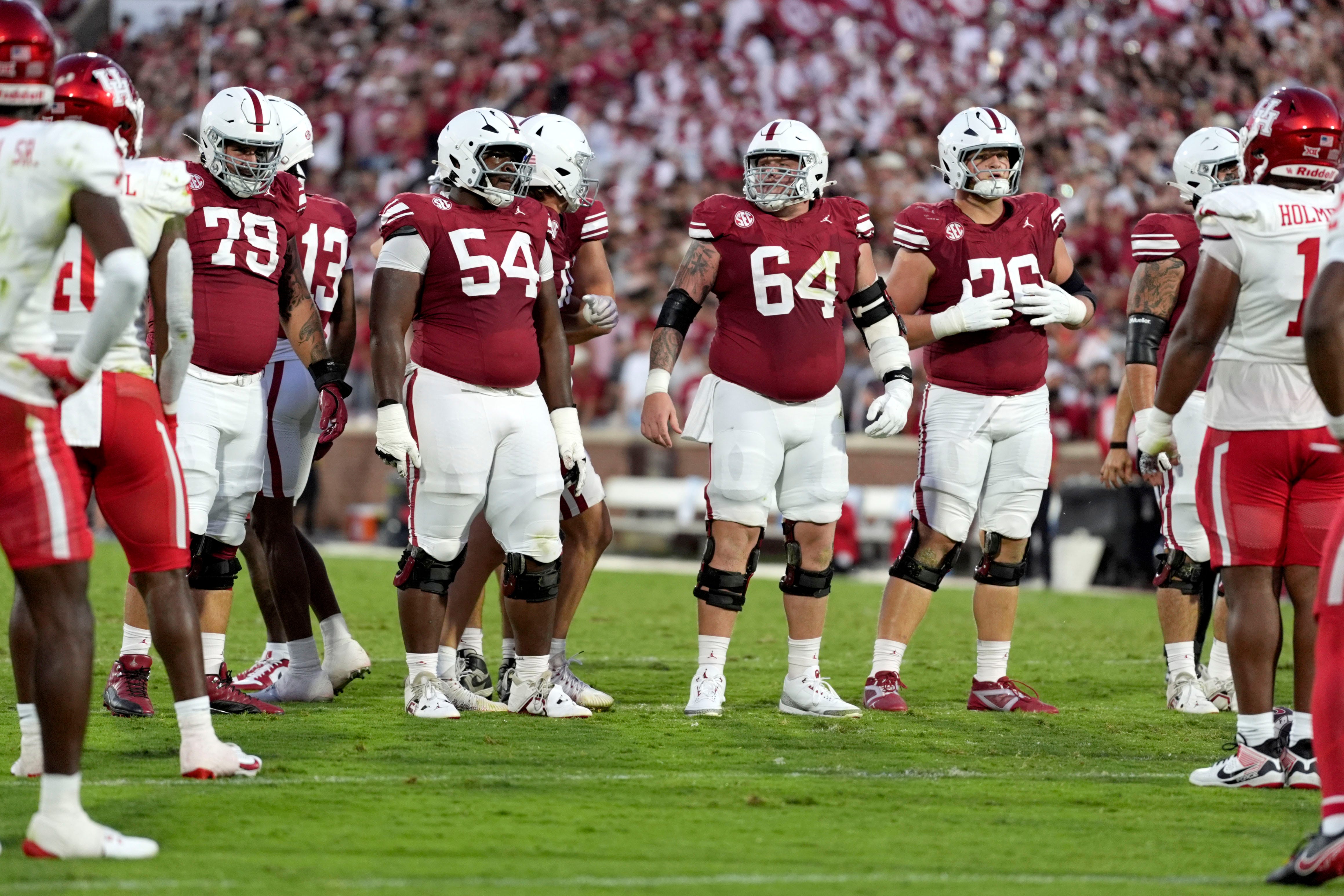 Oklahoma Sooners offensive lineman Jake Taylor (79), offensive lineman Febechi Nwaiwu (54), offensive lineman Joshua Bates (64) and offensive lineman Jacob Sexton (76) walk to the line during a college football game between the University of Oklahoma Sooners (OU) and the Houston Cougars at Gaylord Family–Ð Oklahoma Memorial Stadium in Norman, Okla., Saturday, Sept. 7, 2024.