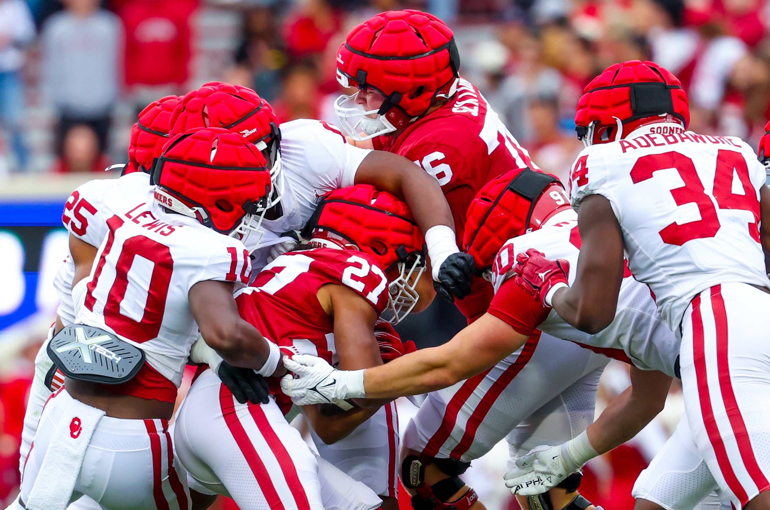 Apr 20, 2024; Norman, OK, USA; Oklahoma Sooners running back Gavin Sawchuk (27) is tackled by Oklahoma Sooners linebacker Kip Lewis (10) and Oklahoma Sooners defensive back Michael Boganowski (25) during the Oklahoma Sooners spring game at Gaylord Family OK Memorial Stadium. Mandatory Credit: Kevin Jairaj-Imagn Images