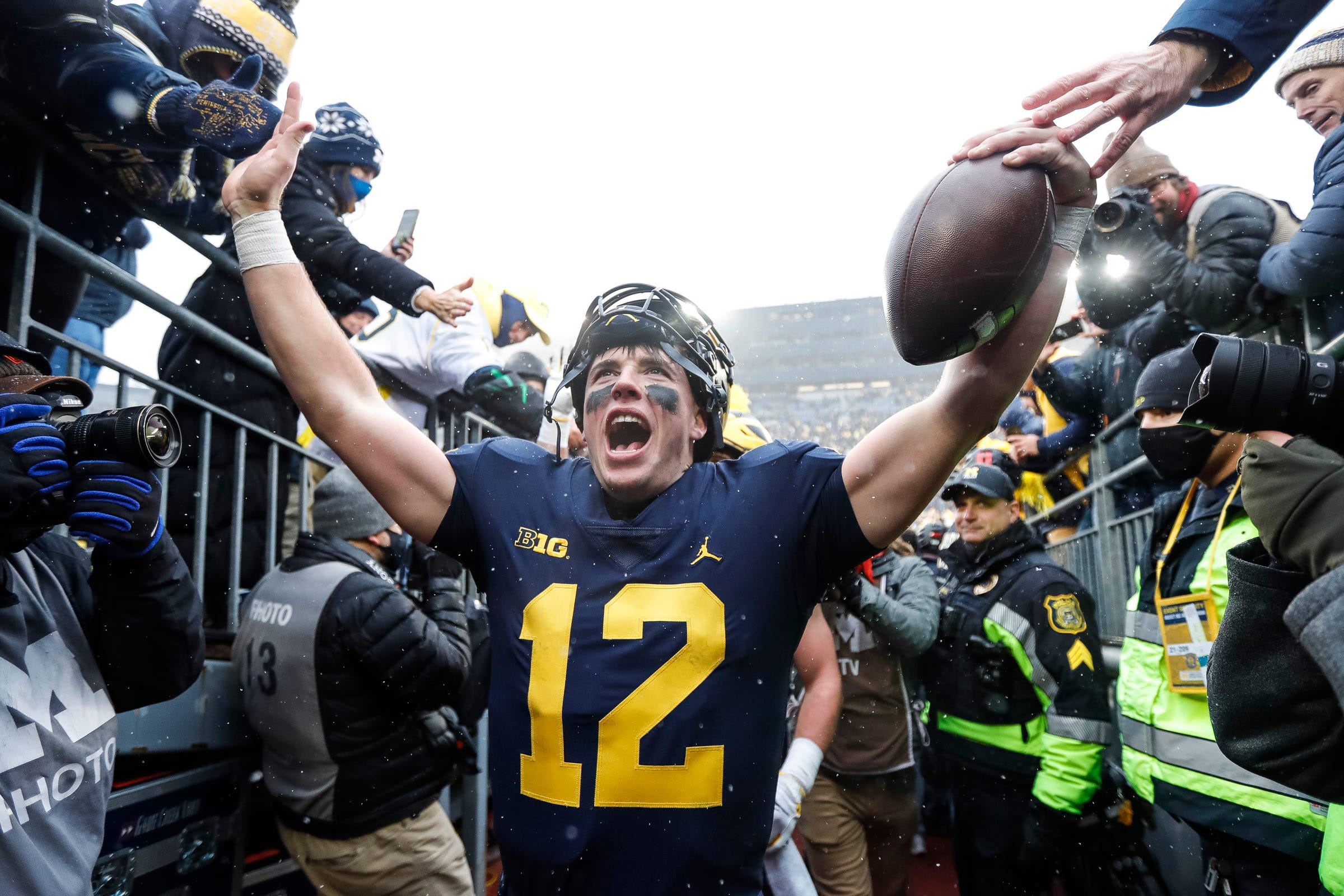 Nov 27, 2021; Ann Arbor, MI, USA; Michigan quarterback Cade McNamara celebrates with fans as he walks up the tunnel after Michigan's 42-27 win over Ohio State on Saturday, Nov. 27, 2021, at Michigan Stadium. Mandatory Credit: Junfu Han-Imagn Images