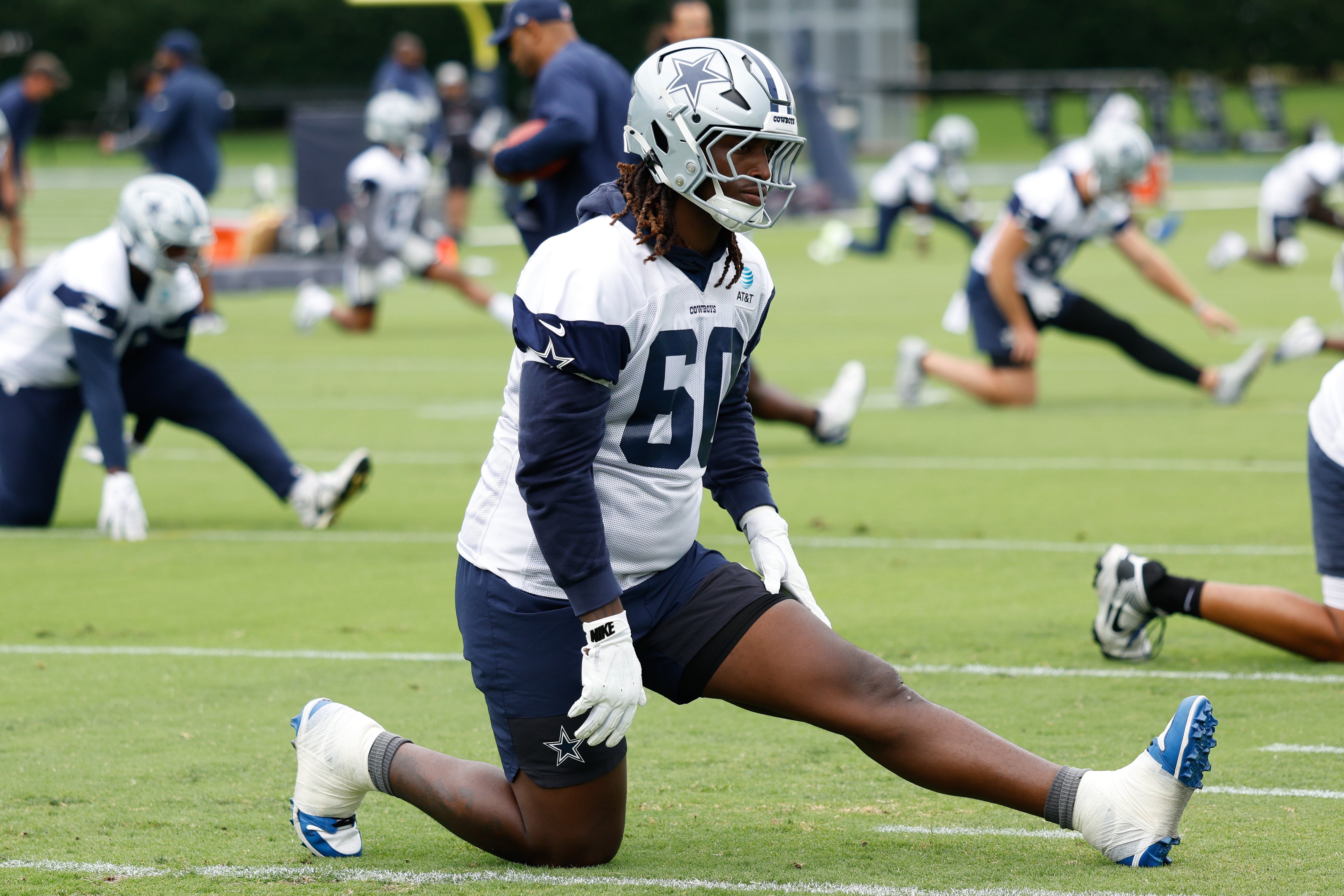 Jun 10, 2025; Arlington, TX, USA; Dallas Cowboys offensive tackle Tyler Guyton (60) goes through a drill during practice at the Ford Center at the Star Training Facility in Frisco, Texas.