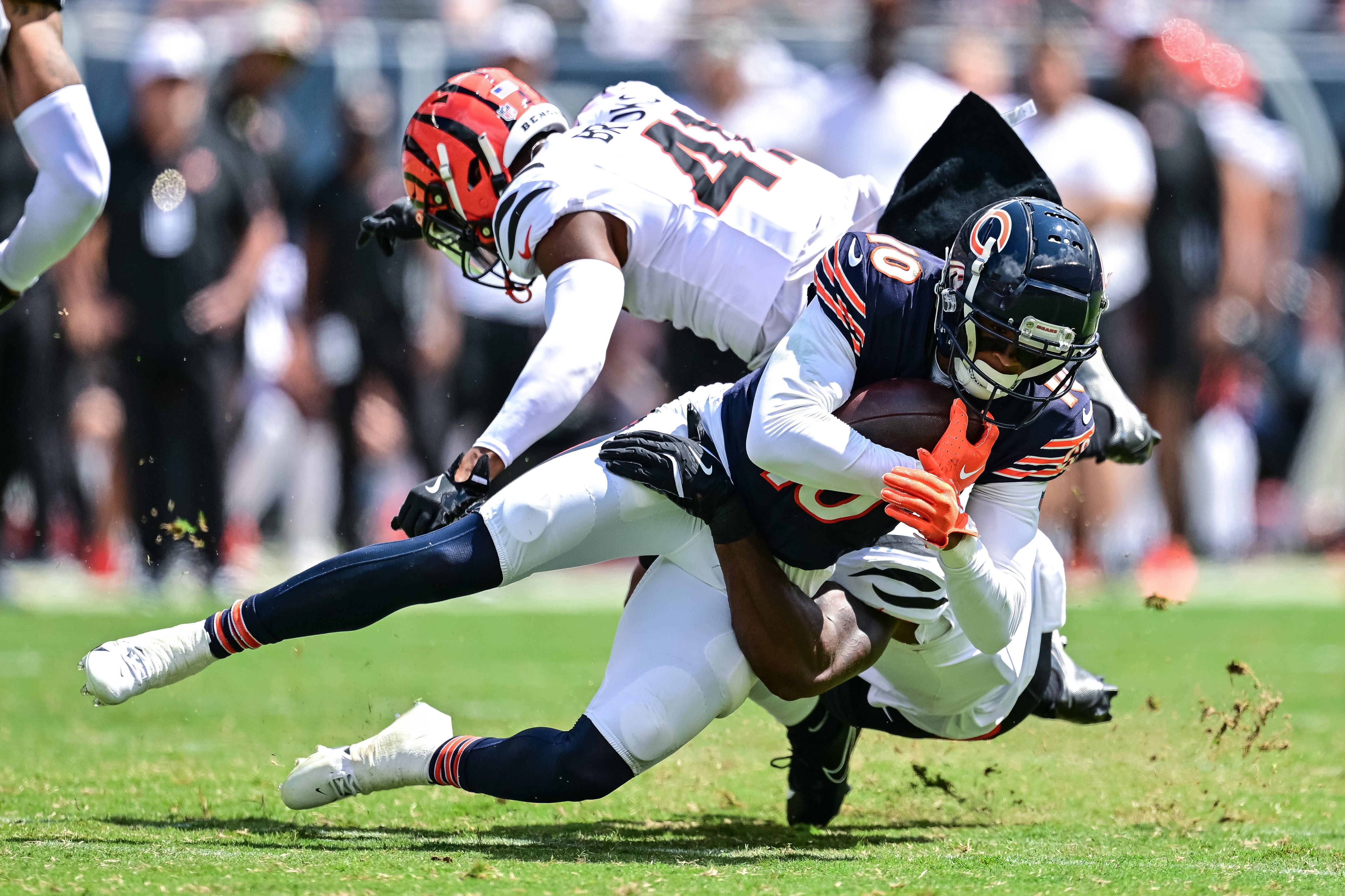 Aug 17, 2024; Chicago, Illinois, USA; Chicago Bears wide receiver Tyler Scott (10) is tackled after a catch by Cincinnati Bengals cornerback Nate Brooks (41) and linebacker Shaka Heyward (50) during the third quarter at Soldier Field.