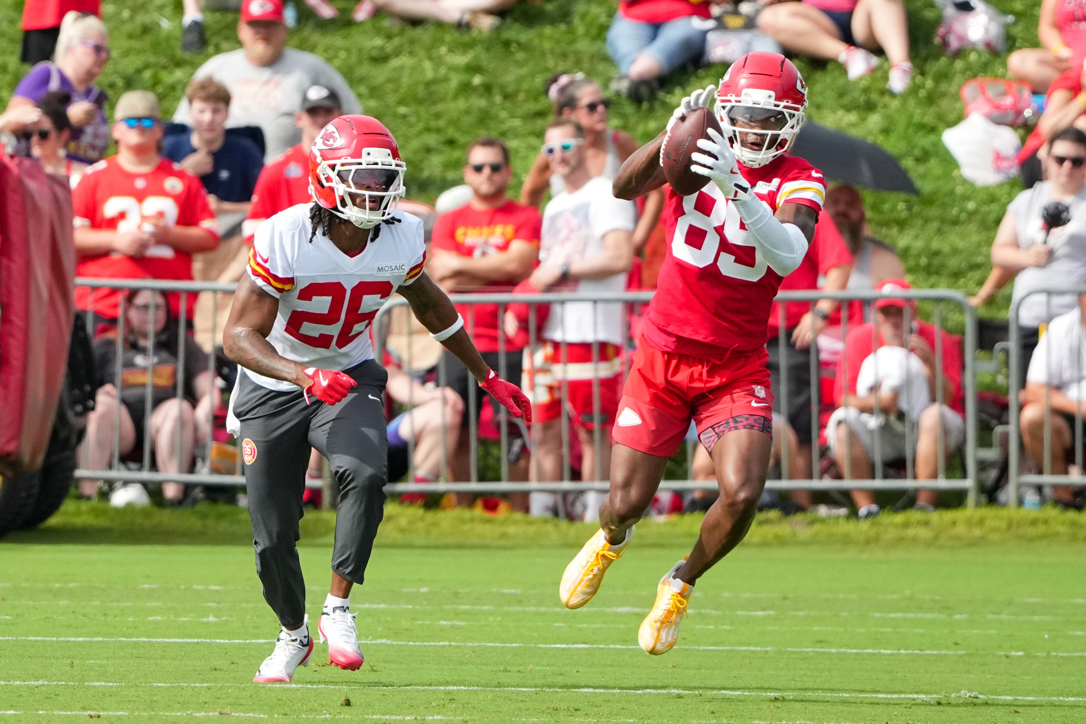 Jul 22, 2025; St. Joseph, MO, USA; Kansas City Chiefs wide receiver Jason Brownlee (89) catches a pass as safety Deon Bush (26) defends during training camp at Missouri Western State University.