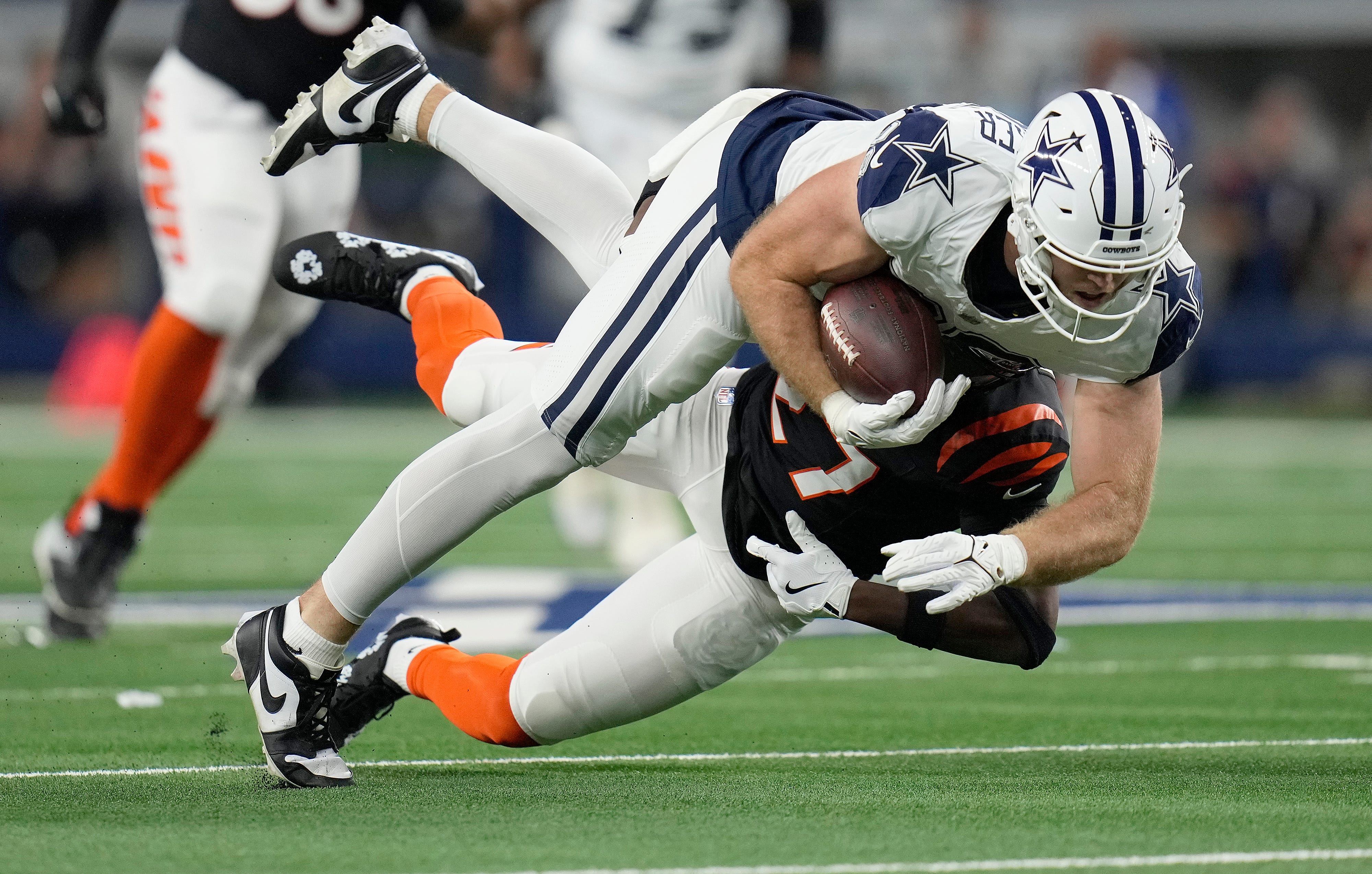 Dallas Cowboys tight end Luke Schoonmaker (86) is taken down by Cincinnati Bengals safety Jordan Battle (27) in the first quarter during Monday Night Football at AT&T Stadium in Arlington, Texas on Monday, December 9, 2024.