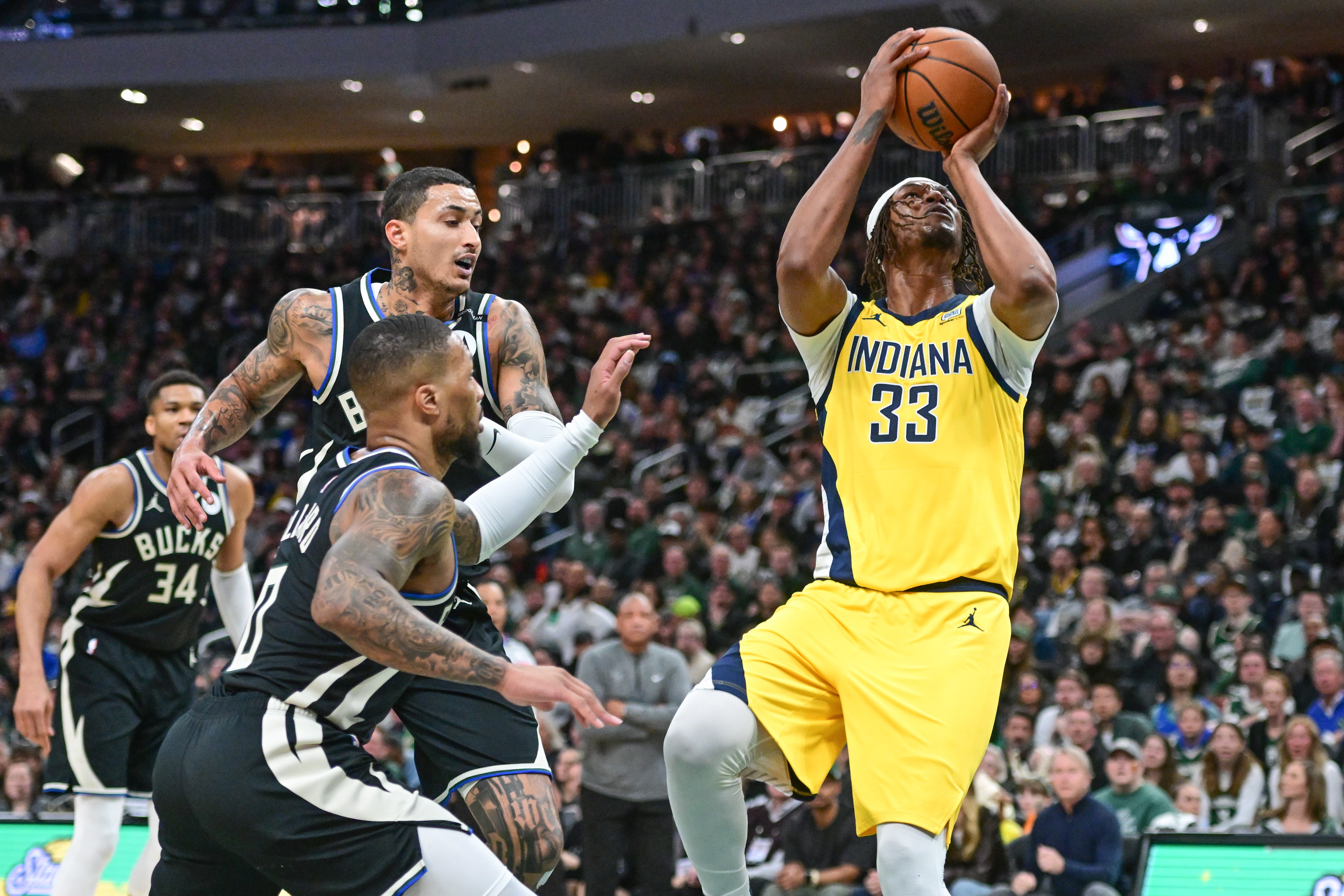 Indiana Pacers center Myles Turner (33) takes a shot against Milwaukee Bucks guard Damian Lillard (0) and forward Kyle Kuzma (18) in the first quarter during game four of first round for the 2024 NBA Playoffs at Fiserv Forum.