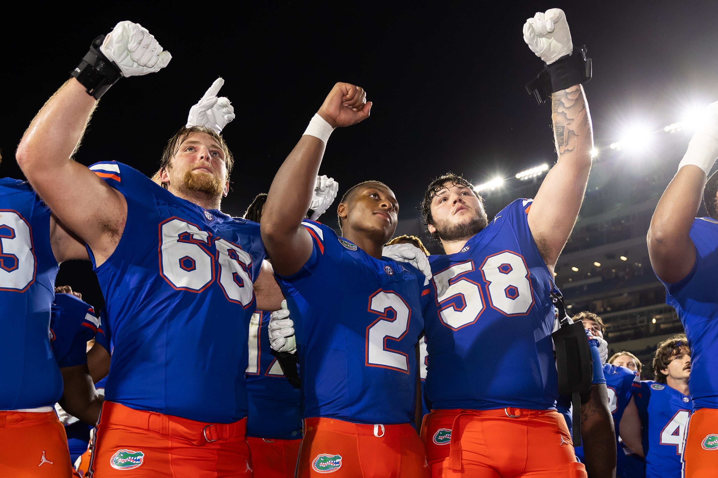 Sep 7, 2024; Gainesville, Florida, USA; Florida Gators offensive lineman Jake Slaughter (66), quarterback DJ Lagway (2), and offensive lineman Austin Barber (58) celebrate against the Samford Bulldogs after the game at Ben Hill Griffin Stadium.