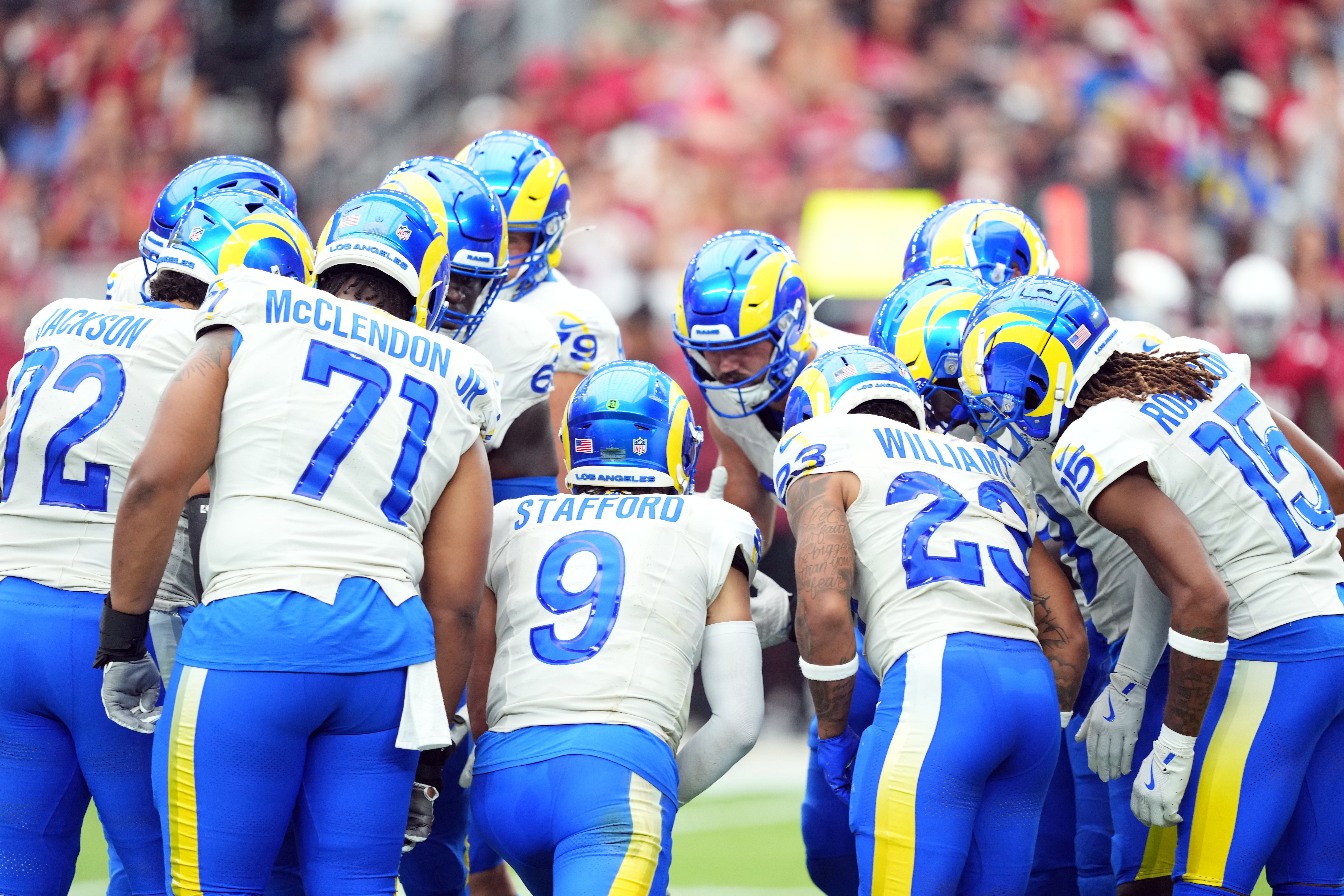 Sep 15, 2024; Glendale, Arizona, USA; Los Angeles Rams quarterback Matthew Stafford (9) huddles teammates against the Arizona Cardinals during the first half at State Farm Stadium.