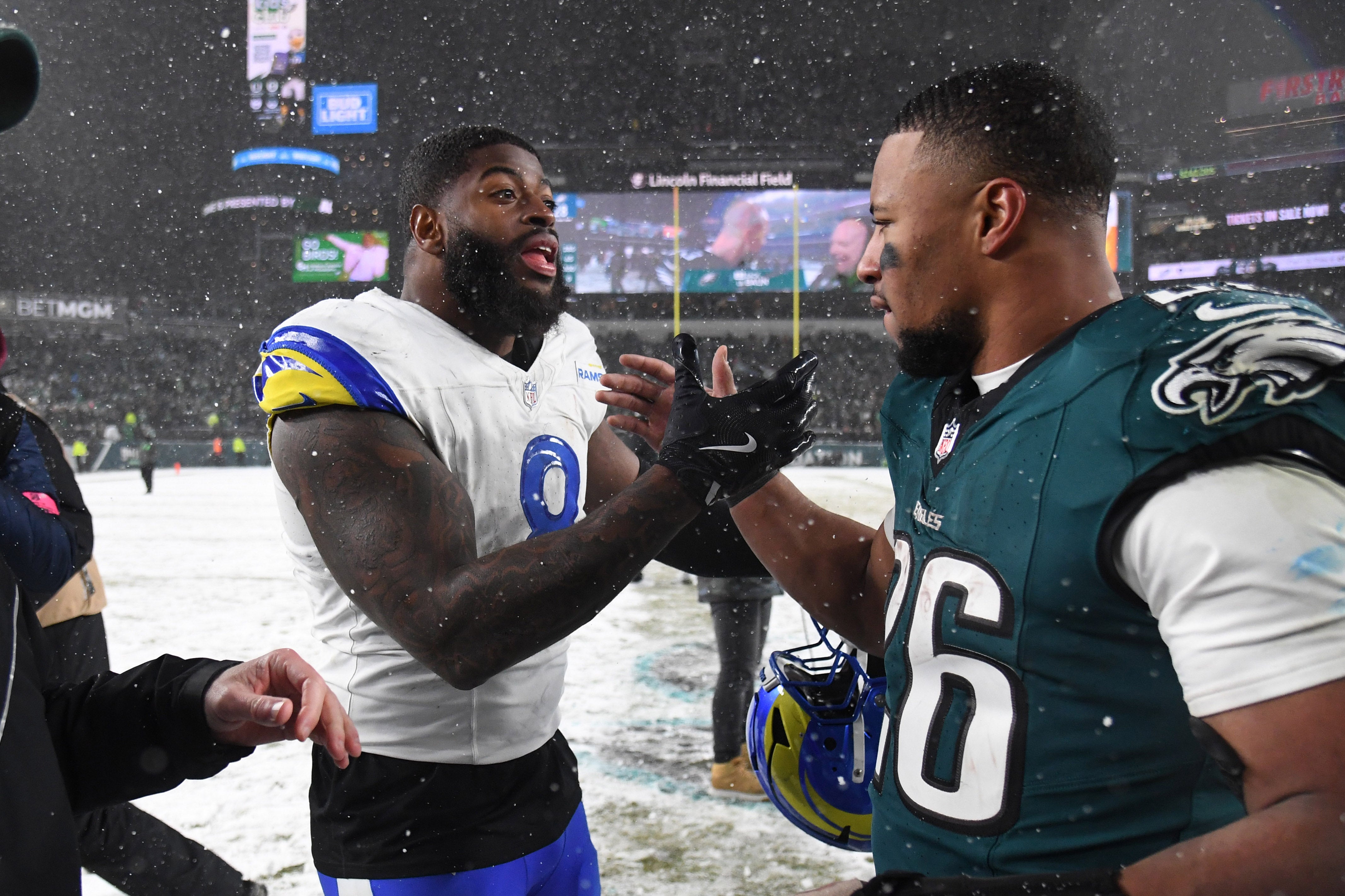 Los Angeles Rams linebacker Jared Verse (8) greets Philadelphia Eagles running back Saquon Barkley (26) after their 2025 NFC divisional round game at Lincoln Financial Field.