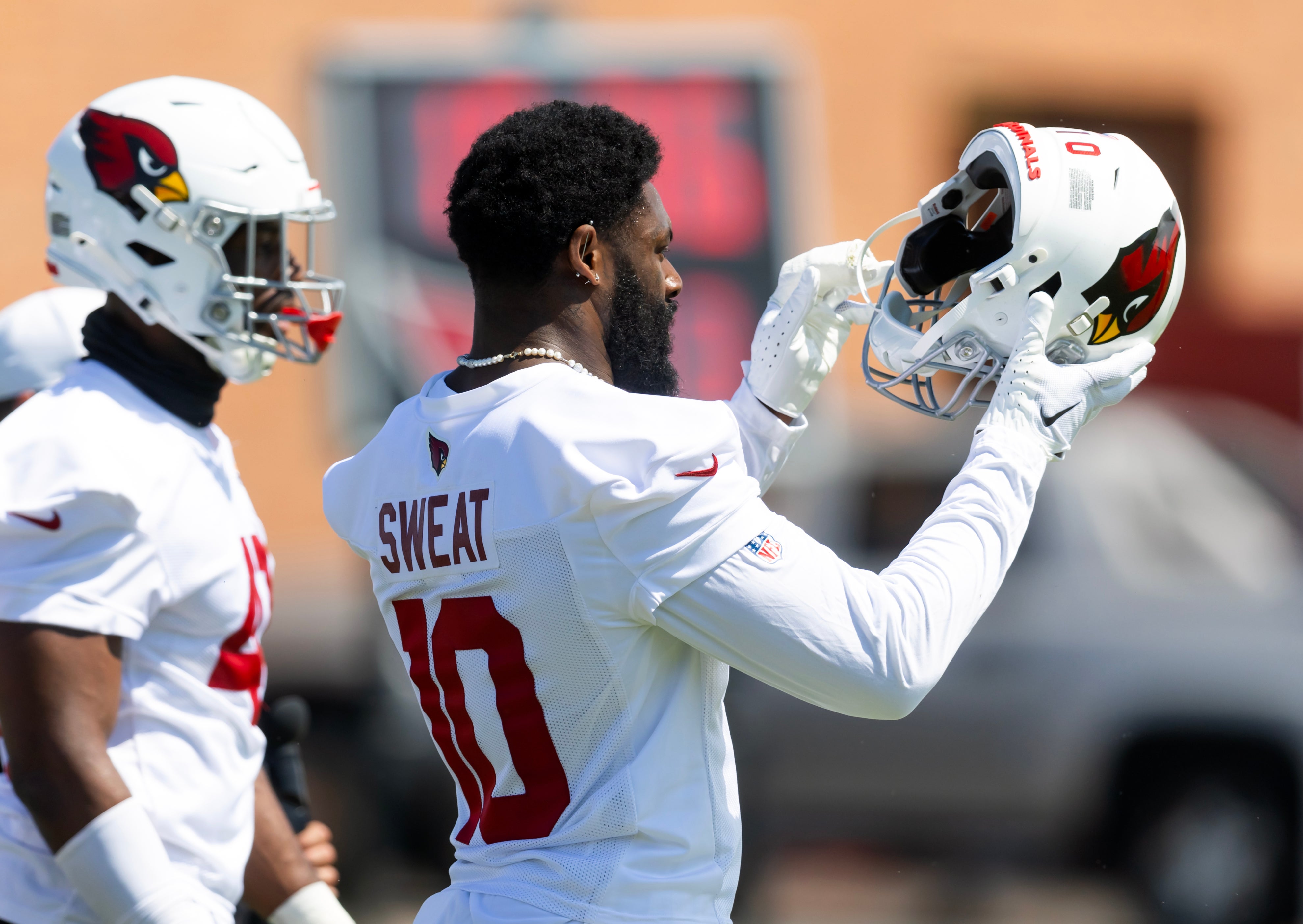 Arizona Cardinals linebacker Josh Sweat (10) puts on his helmet during minicamp at the teams Arizona Cardinals Training Facility.