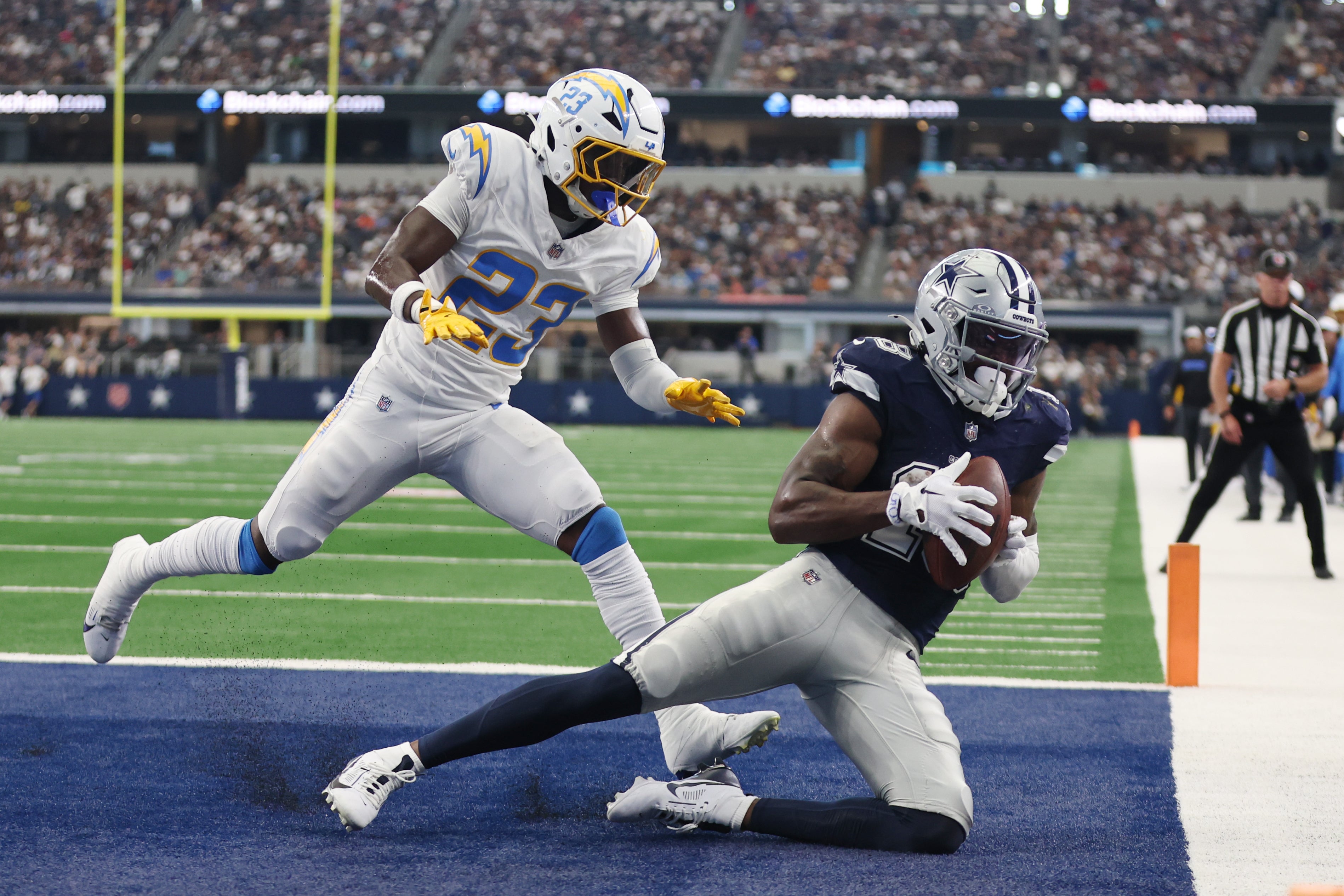 Dallas Cowboys wide receiver Ryan Flournoy (18) catches a touchdown pass against Los Angeles Chargers cornerback Matt Hankins (23) in the second quarter at AT&T Stadium.