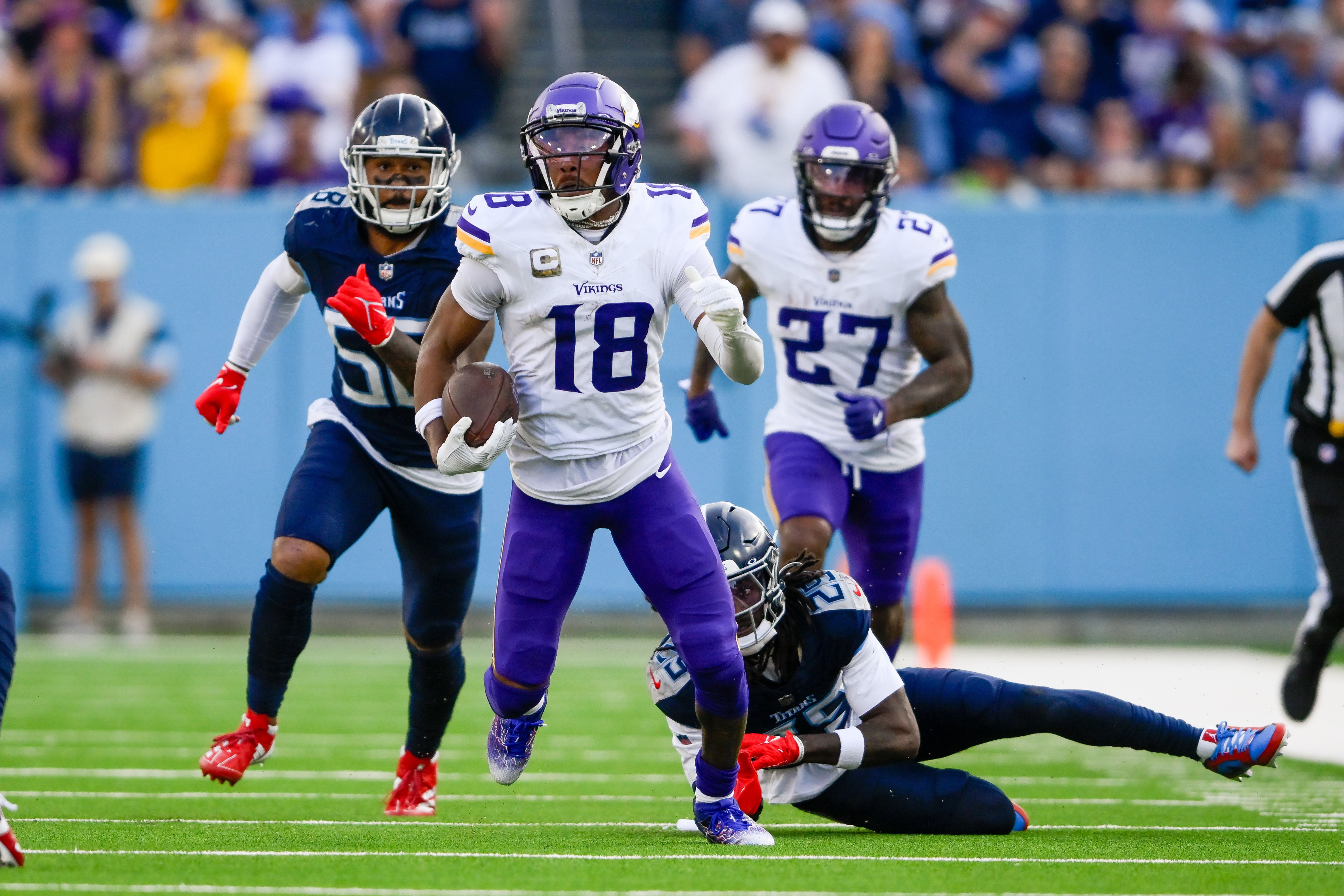 Nov 17, 2024; Nashville, Tennessee, USA; Minnesota Vikings wide receiver Justin Jefferson (18) breaks the tackle of Tennessee Titans cornerback Jarvis Brownlee Jr. (29) during the first half at Nissan Stadium.