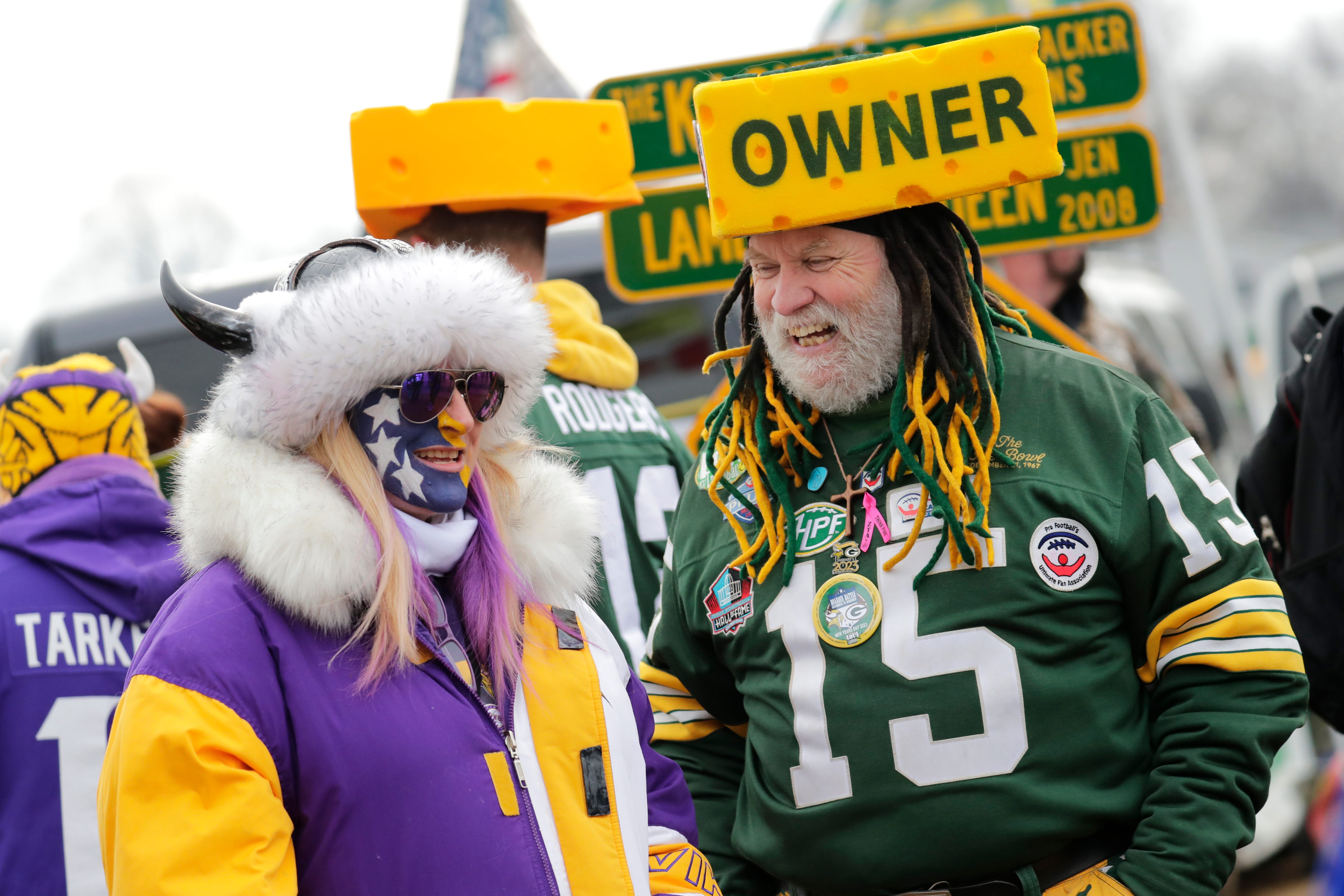 Minnesota Vikings fan Tali Roberts, left, of Nashville shares a laugh Green Bay Packers fan Steve Tate of DeForest, Wisconsin, prior to the start of their football game at Lambeau Field in Green Bay, Wisconsin.