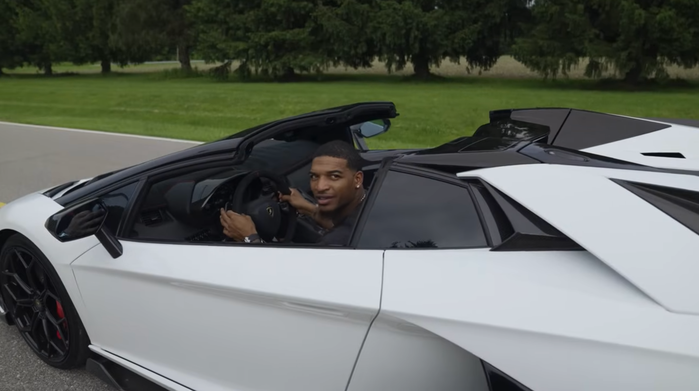 Cincinnati Bengals WR Ja'Marr Chase behind the wheel of his Lamborghini.