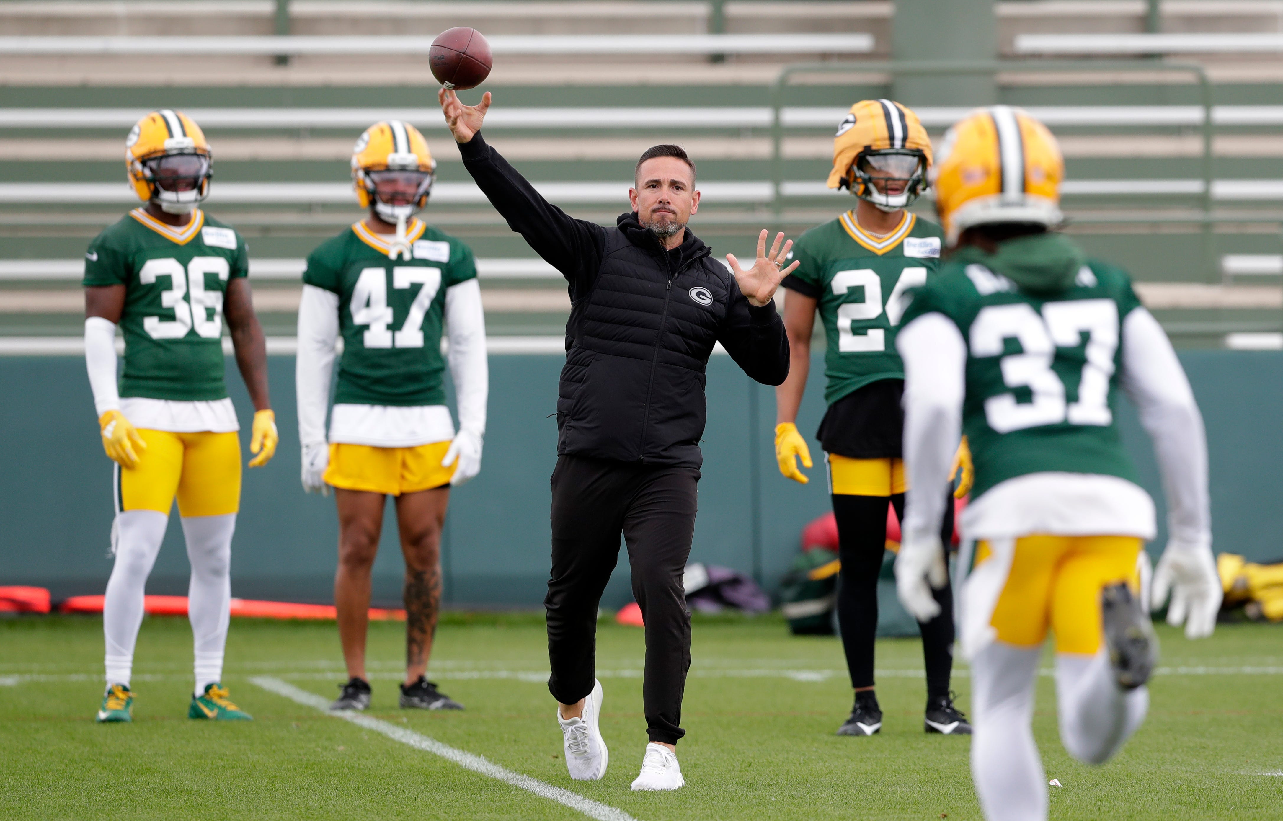 Green Bay Packers head coach Matt LaFleur throws the the ball to cornerback Johnathan Baldwin (37) during the team's first day of minicamp on June 10, 2025, at Ray Nitschke Field in Ashwaubenon, Wis.