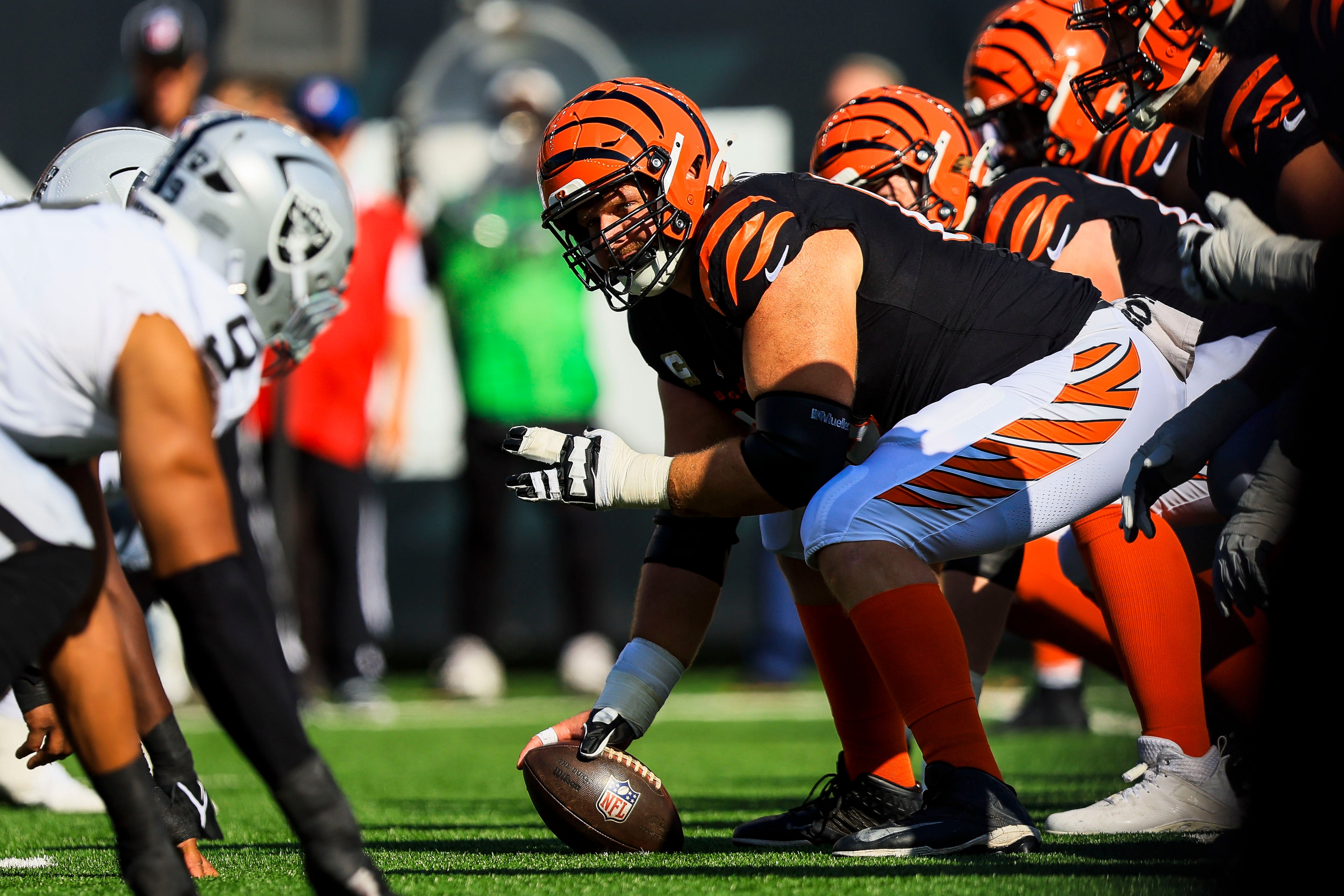Nov 3, 2024; Cincinnati, Ohio, USA; Cincinnati Bengals center Ted Karras (64) prepares to snap the ball against the Las Vegas Raiders in the first half at Paycor Stadium.