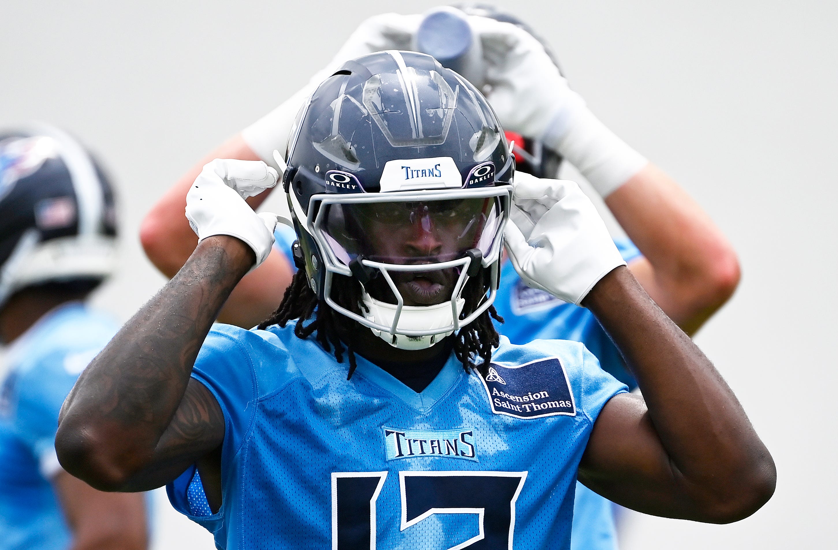 Tennessee Titans tight end Chig Okonkwo snaps his chin straps during an NFL football minicamp camp practice at Ascension Saint Thomas Sports Park Thursday, June 12, 2025, in Nashville, Tenn.